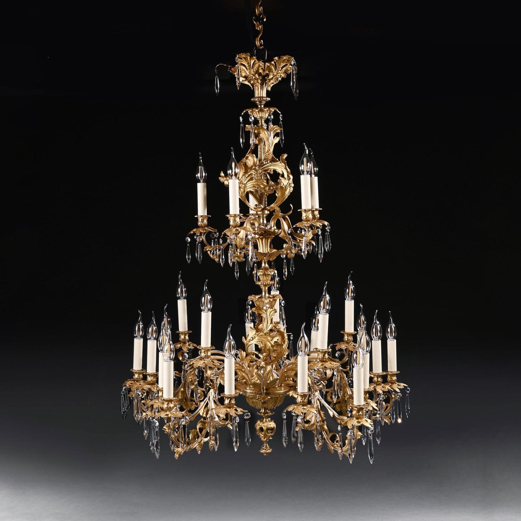 A wonderfully impressive large gilt bronze and cut glass lustre, twenty-five-light two-tier chandelier in the Louis XV style.

French late 19th Century - Circa 1890-1900.

Of Rococo design with tiers of glass lustres, the foliate cast corona