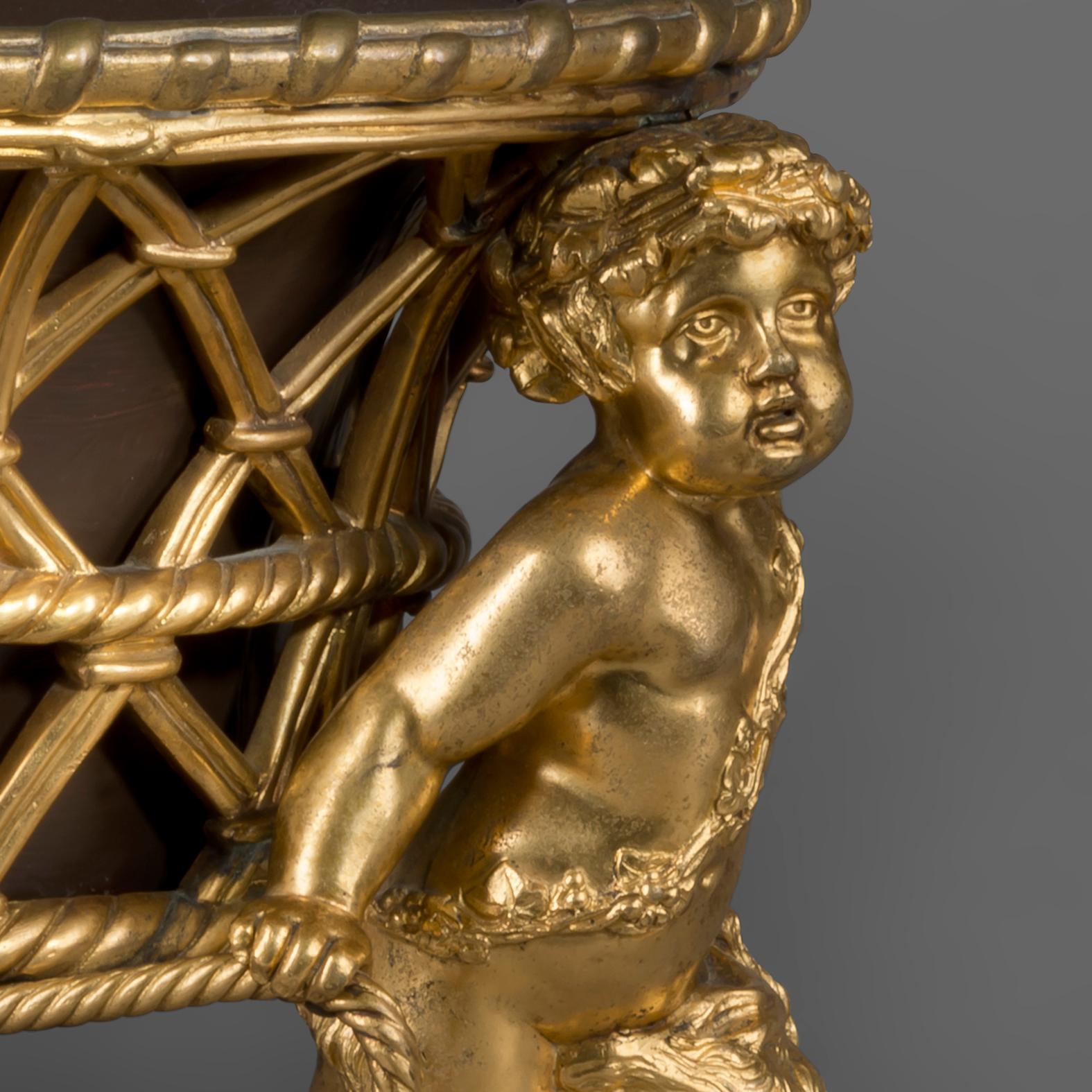 A Louis XV style gilt bronze Jardinière by Maison Alphonse Giroux.

Stamped 'Maison Alph GIROUX' a Paris'.

This elegant jardinière is in the form of an oval basket suspended between ropes by two finely cast putti. The jardinière retains its