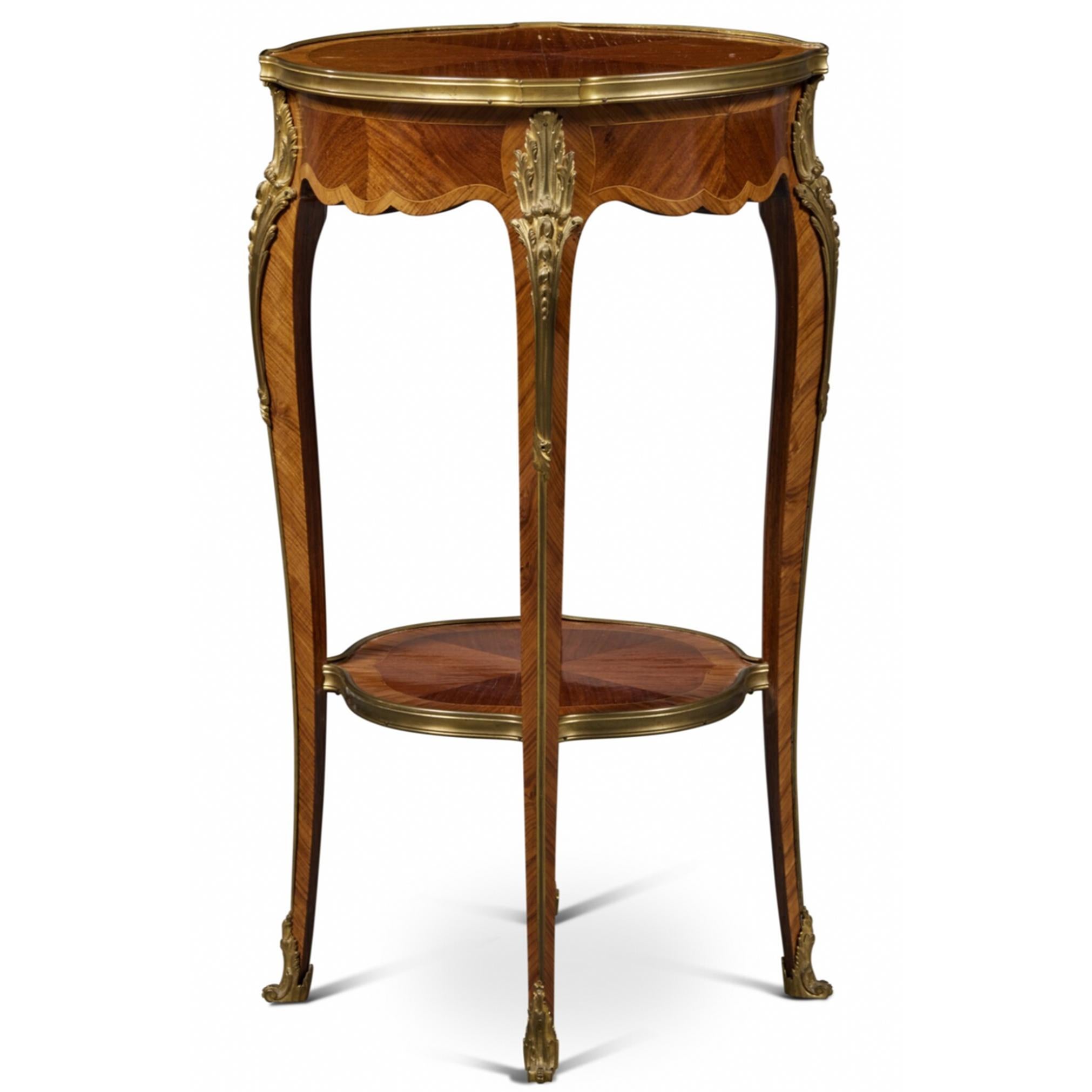 A Louis XV Style Gilt-Bronze Mounted Bois Satiné and Kingwood Side Table, Circa 1900 with a brilliantly detailed veneer, showcasing three shades of wood in contrasting browns, crating a simple and alluring design. 

74.9 cm; 43.2 cm

François