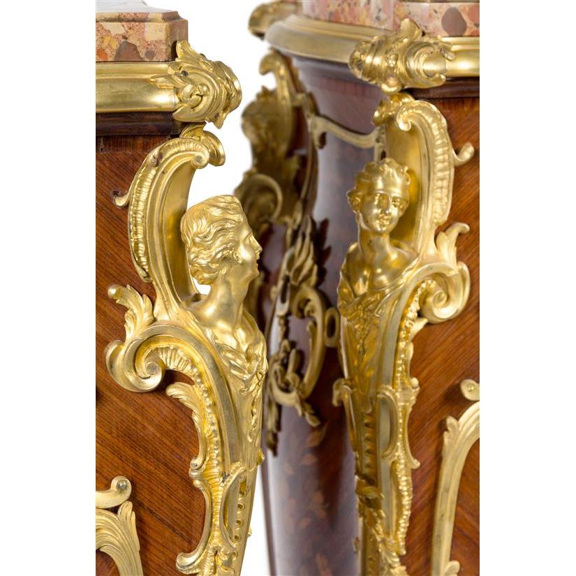 A Fine Pair of Louis XV Style Gilt Bronze Mounted Marquetry Pedestals with breche d'alep marble inset top
attributed to Theodore Millet, the pedestals of bombe form with female busts at all four corners, inlaid throughout to show ribbon-tied