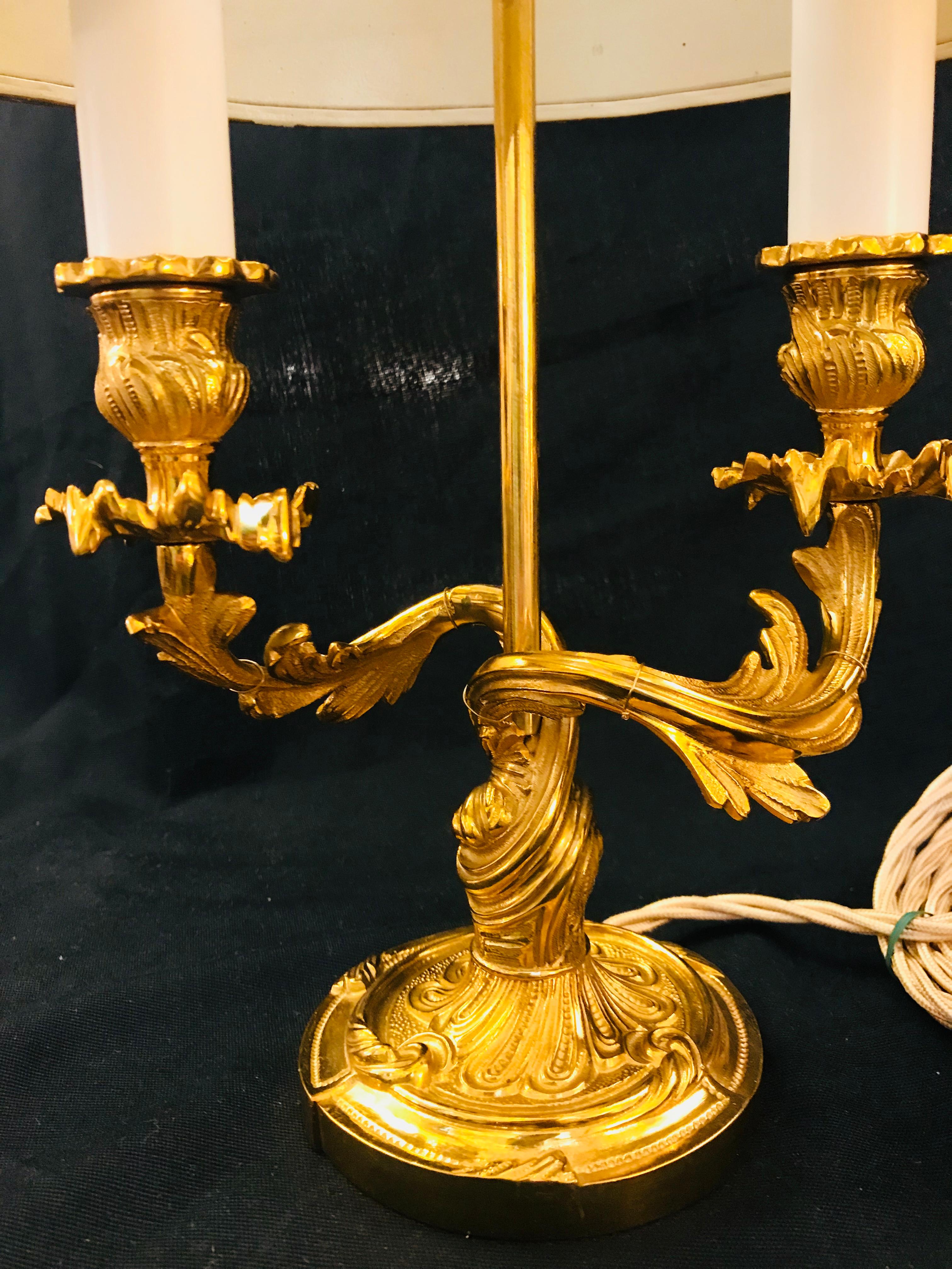 This Louis XV style gilt bronze lamp resume the taste of Rococo period decoration. As this, vegetal motifs are all-over this piece and it features great elegance and opulence in the forms. The stem has got undulations and curls and is topped with a