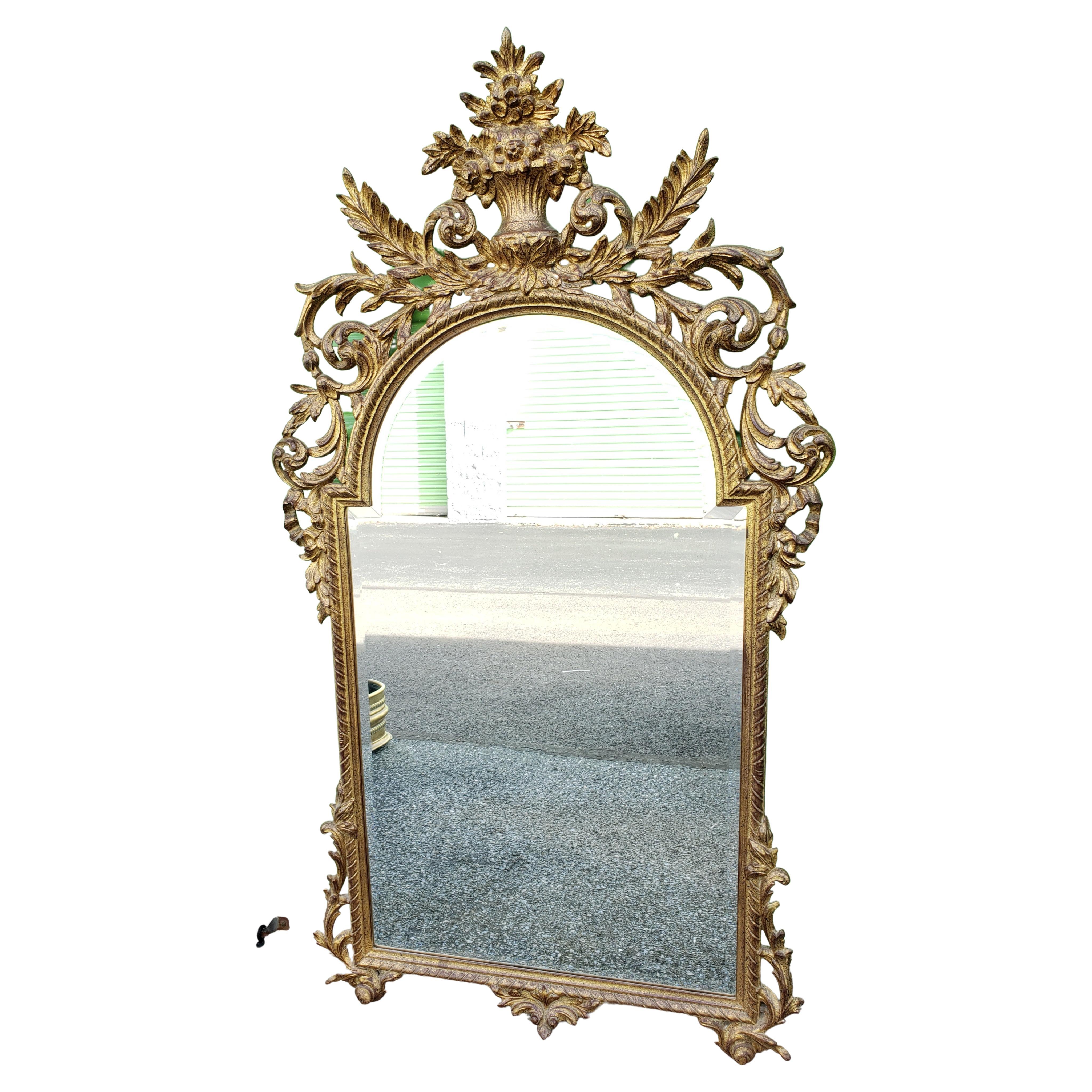 A beautiful Louis XV style gilt decorated beveled wall mirror from Belgium 1964.
Very good vintage condition. 
Measures 31