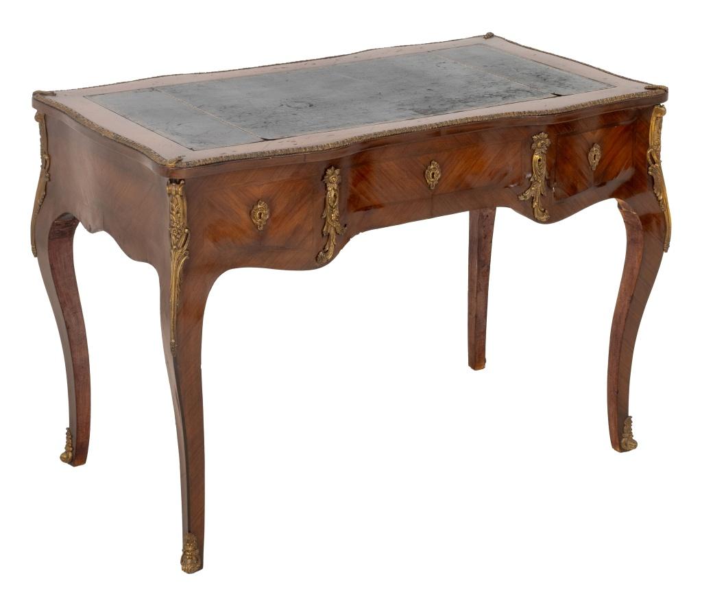 Louis XV Style Gilt Metal Mounted Bureau Plat, with gilt-tooled black leather top above two drawers atop four cabriole legs. 32.25