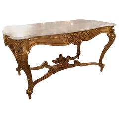 Table centrale de style Louis XV en bois doré et plateau en marbre blanc avec guirlandes de feuillage