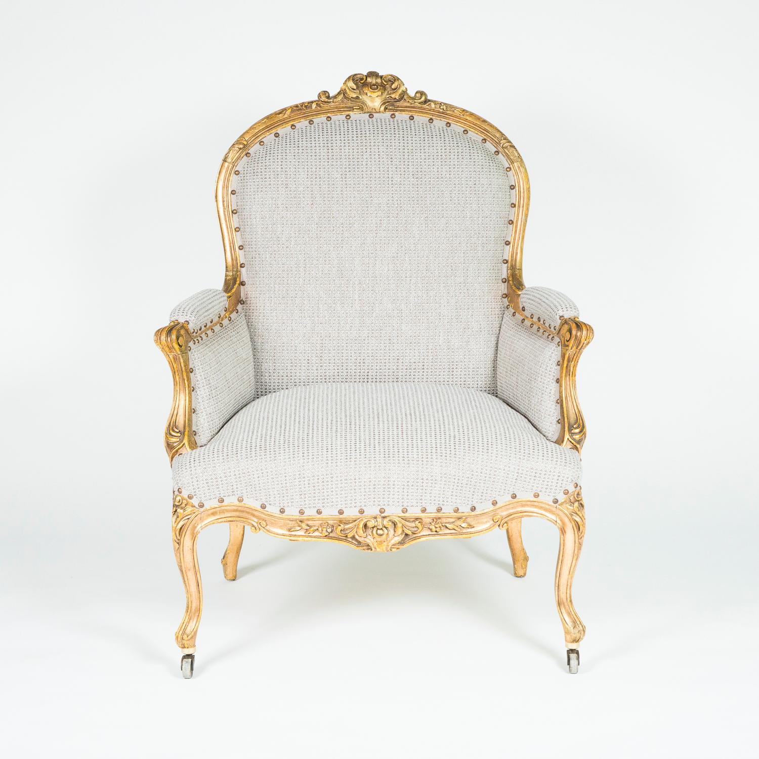 A pair of Louis XV style giltwood bergère armchairs with cabriole legs, upholstered seat, back and arm rests, the front feet on castors.

Recently re-upholstered.
     