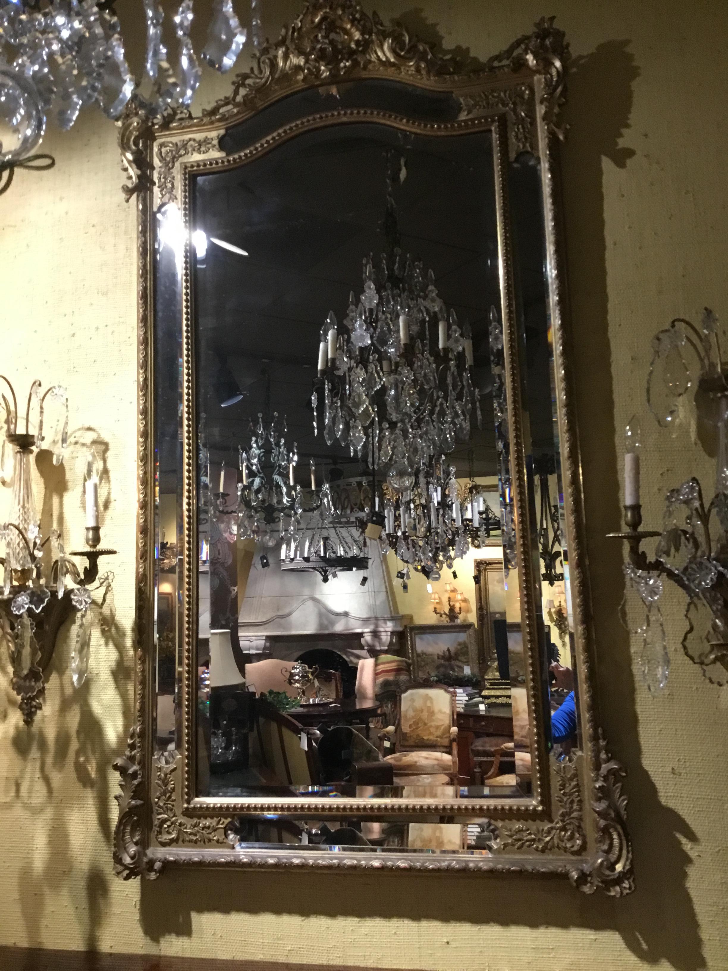 Exquisite double framed mirror with multiple bevels that give this piece
Exceptional spark. Original gilding with beautiful decorated corners and
A cortouche at the crest. Beading separates the mirrors on all sides.