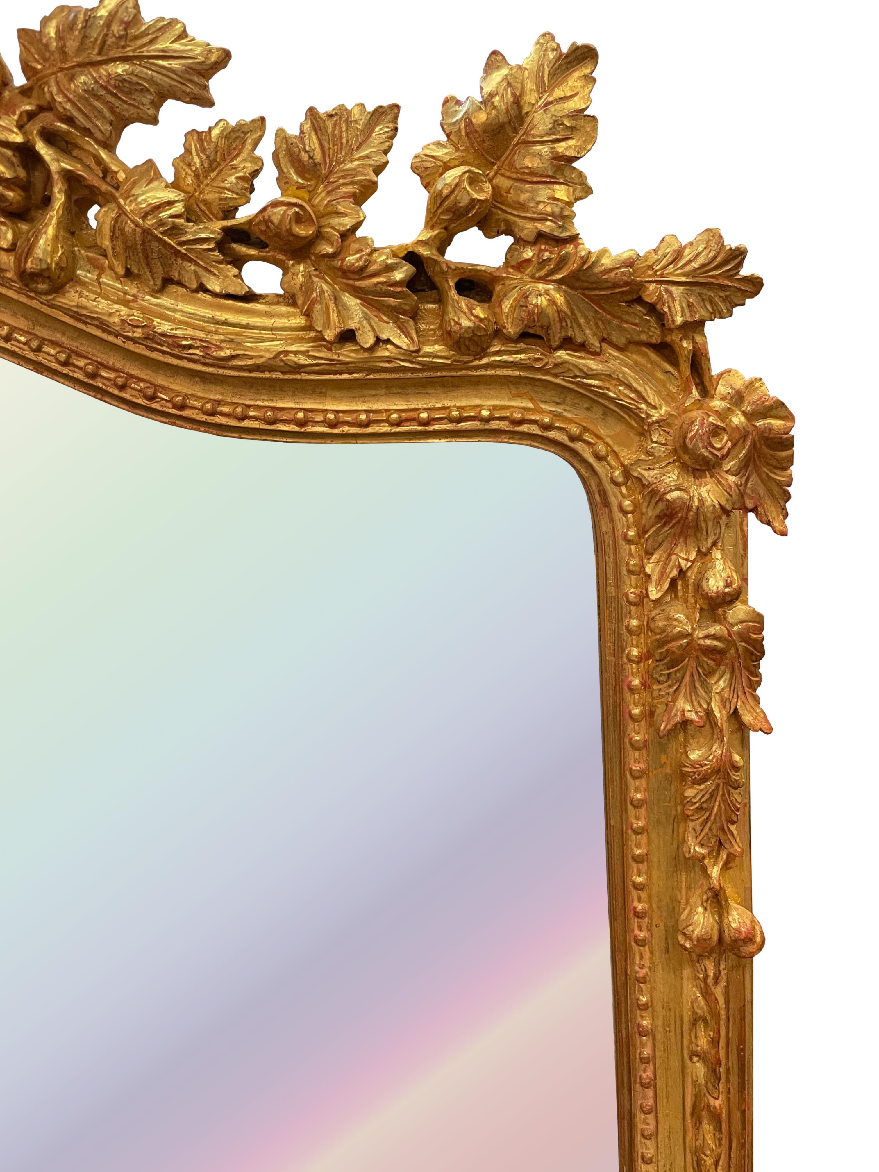 
Louis XV Style Giltwood Mirror
The beveled arched mirror plate within a bead and vine-carved border, the serpentine arched crest carved with fruited leaves and a bow-tied ribbon. 
65 by 36 in. (165.1 x 91.44 cm.)