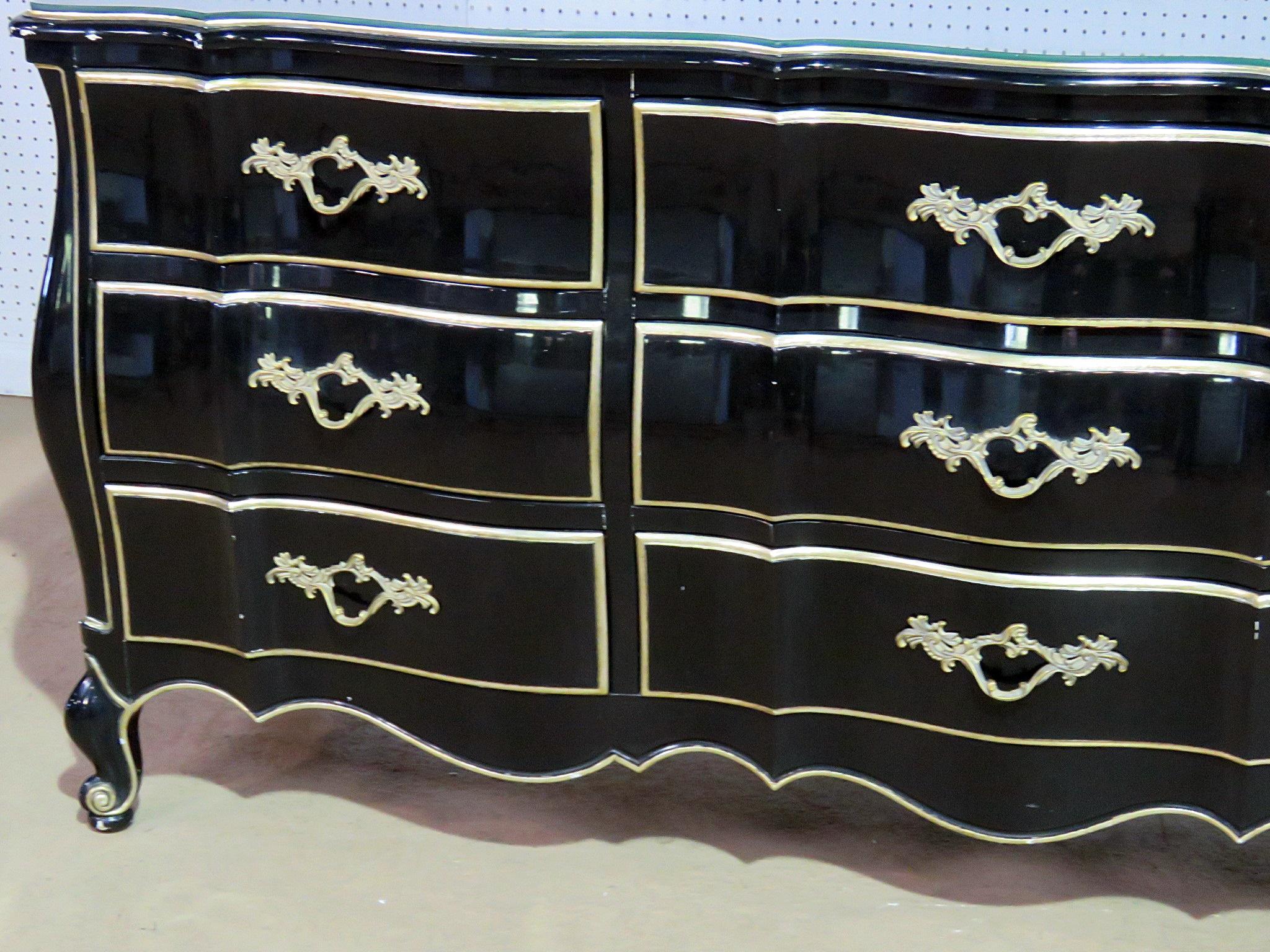 French Provincial style lacquered six-drawer commoder with a glass top and gilt trim by Dixon Powdermaker.