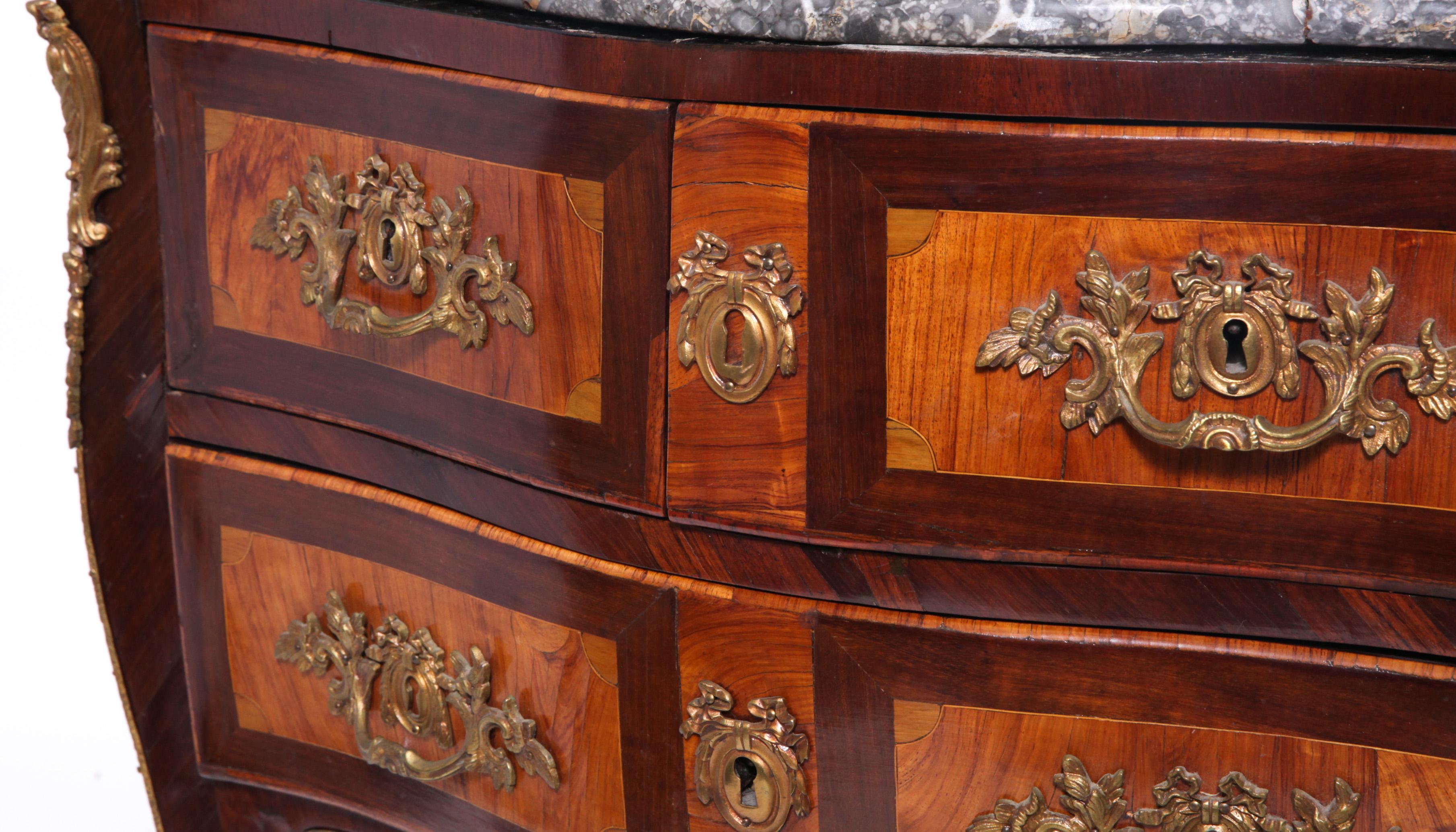 Louis XV style bombe commode with contrasting wood veneer. The piece has two small top drawers and one large bottom drawer as well as bronze mounts and hardware. In great antique condition with old repair work to the gray marble top.