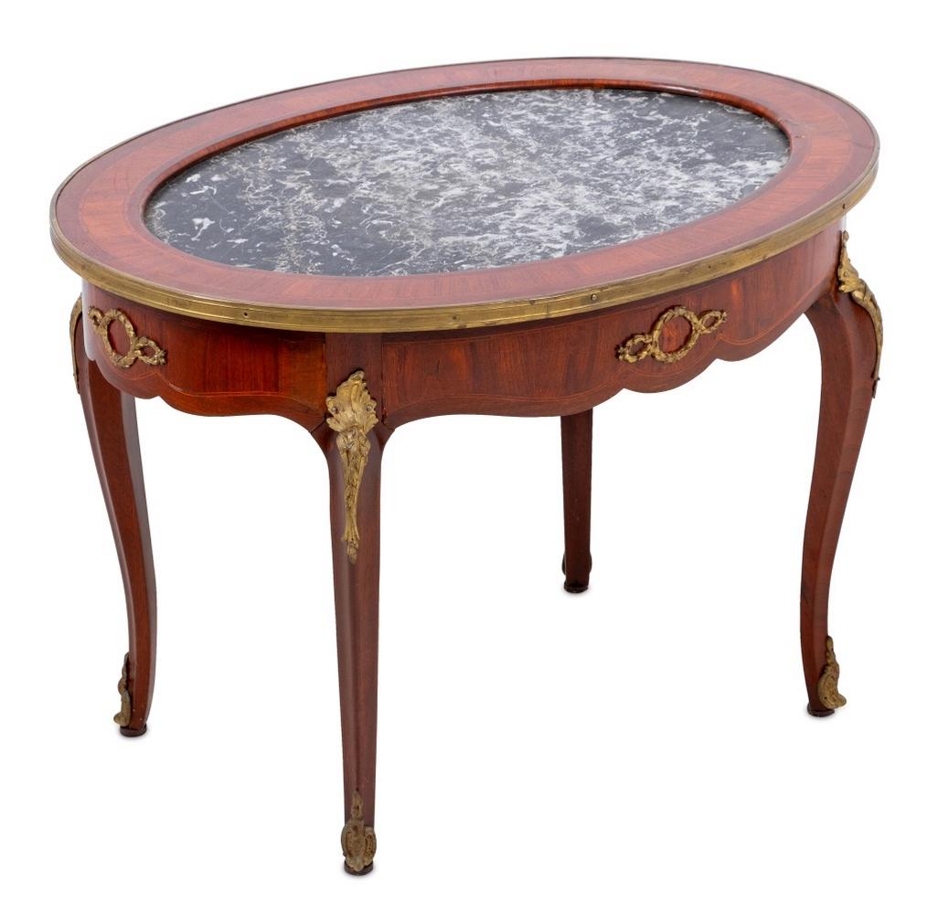 Louis XV Style Gilt Metal Mounted Kingwood Black and Grey Marble Top Oval Low Table, early 20th century, the crossbanded top inset with a marble panel, on a scrolled frieze, with tall cabriole legs. 22