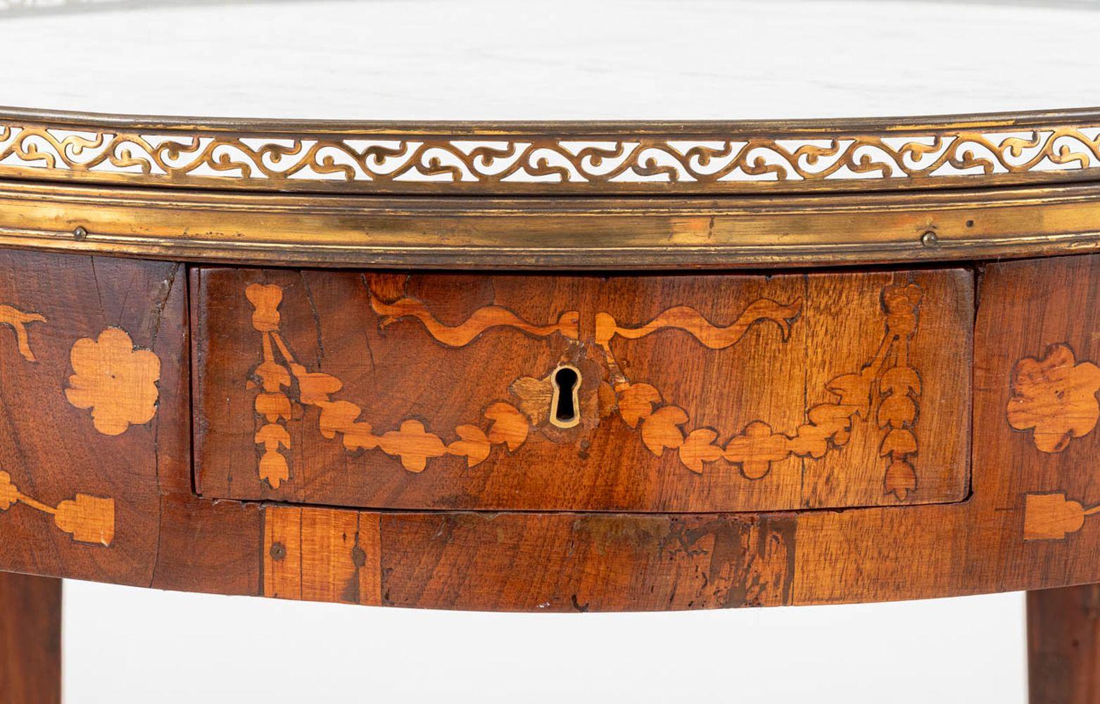 Louis XV Style Kingwood Marquetry Bouillotte Table, 19th century, with pierced brass gallery and white marble circular top, inlaid floral marquetry and single drawer on four cabriole legs with brass mounted feet. 29