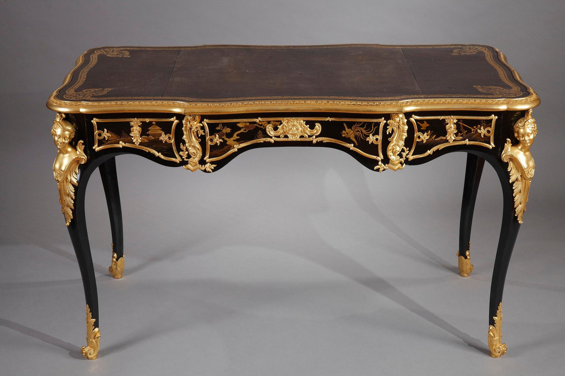 Stamped twice A Beurdeley a Paris on the crosspieces.

Elegant Louis XV style double-side desk in lacquered wood and gilded bronze. It is adorned on all sides, in foliated bronze cartouches, with a decoration of birds and golden landscapes painted
