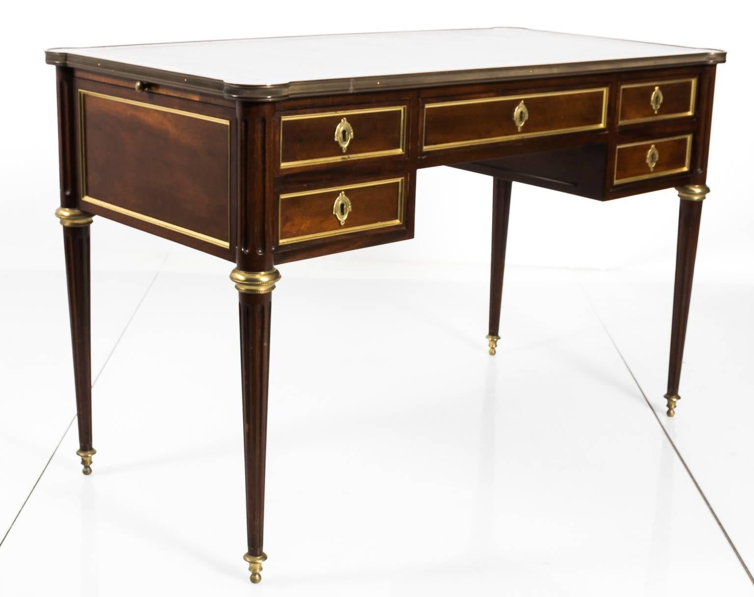 Louis XV style partner's desk that features a leather embossed top, decorative brass escutcheons and tapered fluted legs. Note that the leather top has minor scratches and wear, circa 19th century.
 