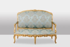 Louis XV style living room with gilded wood frame. Circa 1880.