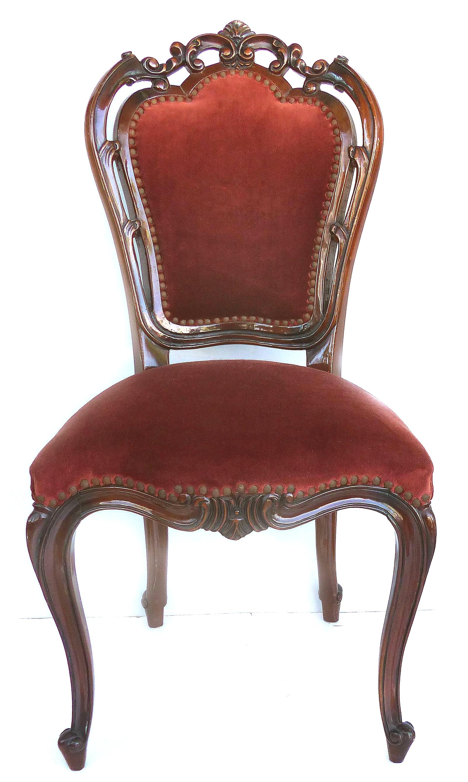 
Louis XV Style Mahogany Dining Chairs with Carved Pierced Backs, Set of Six

Offered for sale is a set of six Louis XV style mahogany dining side chairs with pierced open carved backs, velvet mohair upholstery and nail-head tacks. The chairs are in