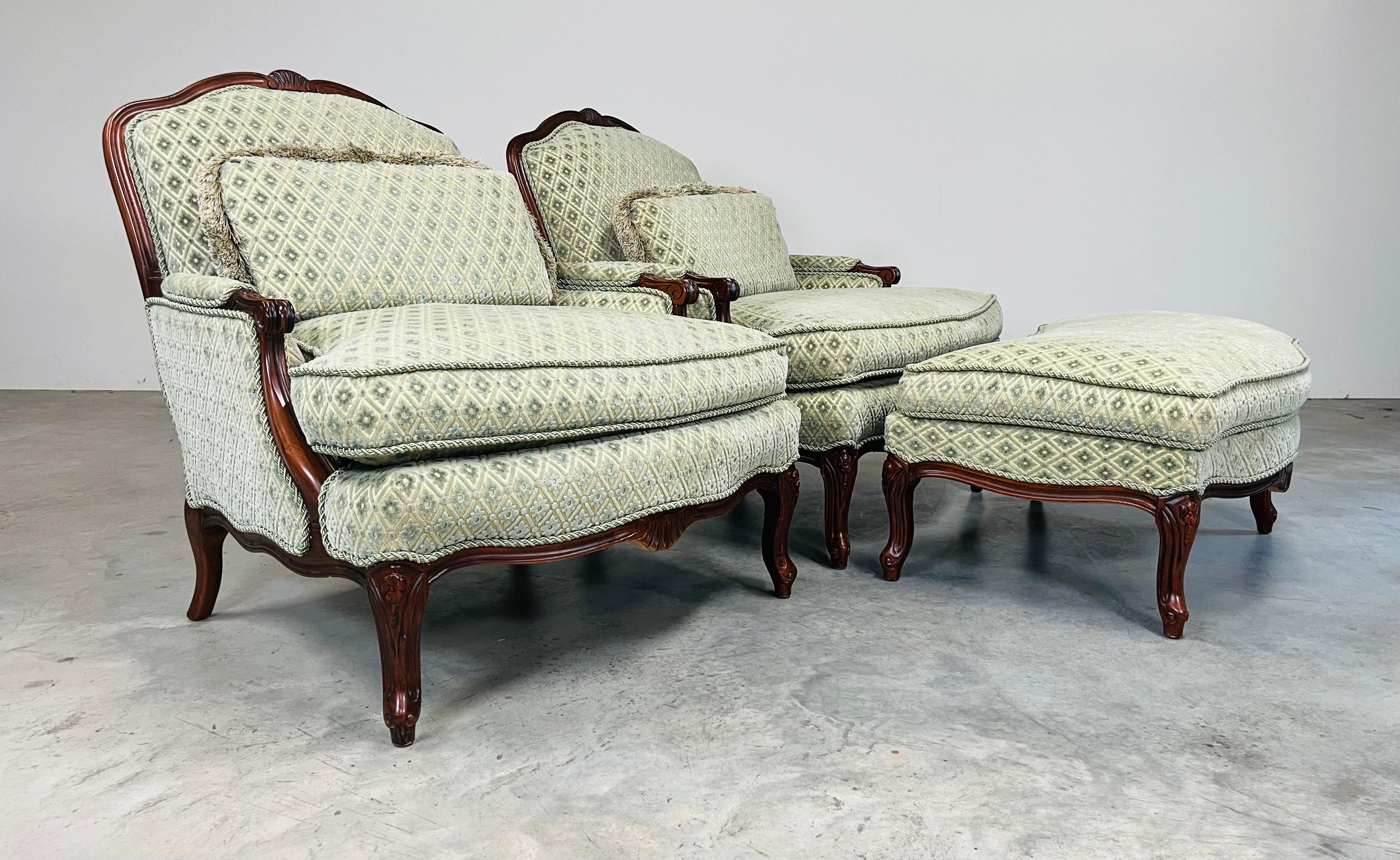 A pair of decorator French Louis XV-style bergère lounge chairs with matching ottoman having hand carved mahogany frames and down cushions covered in aqua diamond velvet and satin blended upholstery that offers a touch of French elegance.
Chairs: