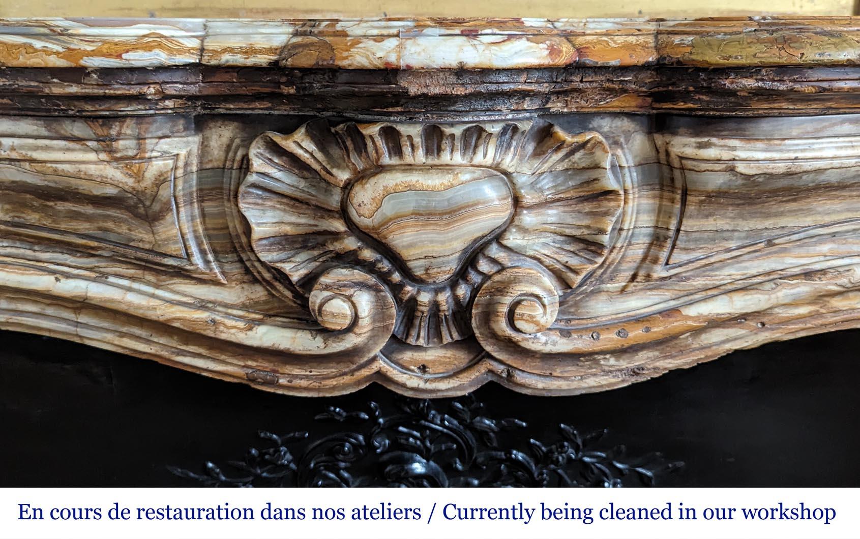 Louis XV style mantel in onyx

This fireplace is sold with its original cast iron insert and with its marble floor.