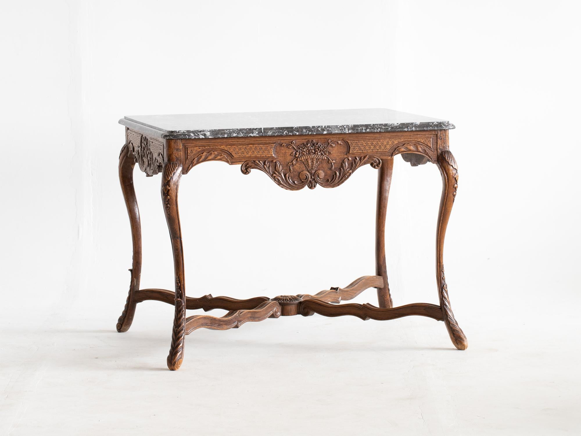 A marble-top oak centre table in the Louis XV taste. French, late 19C.

Intricate carving consistent on all sides with beautifully veined grey marble top.

In very good order with light cosmetic wear.

75 x 99 x 75 cm

29.5 x 39.0 x 29.5 “