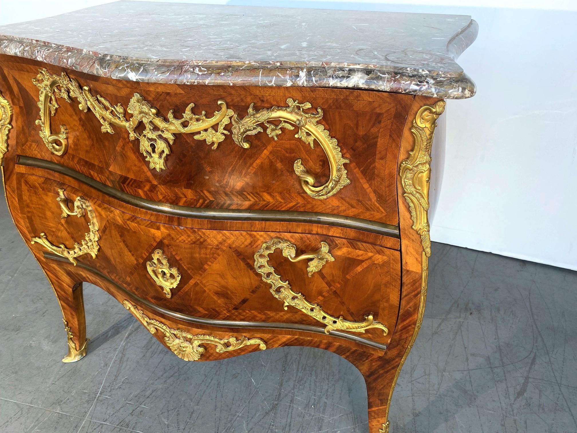 A beautiful Italian Marquetry Marble top Commode / Chest of 2 drawers. Nice gilded decorations. marquetry in Kingwood, Walnut, and Rosewood.  Old Swiss/ German Railroad Lable on reverse.