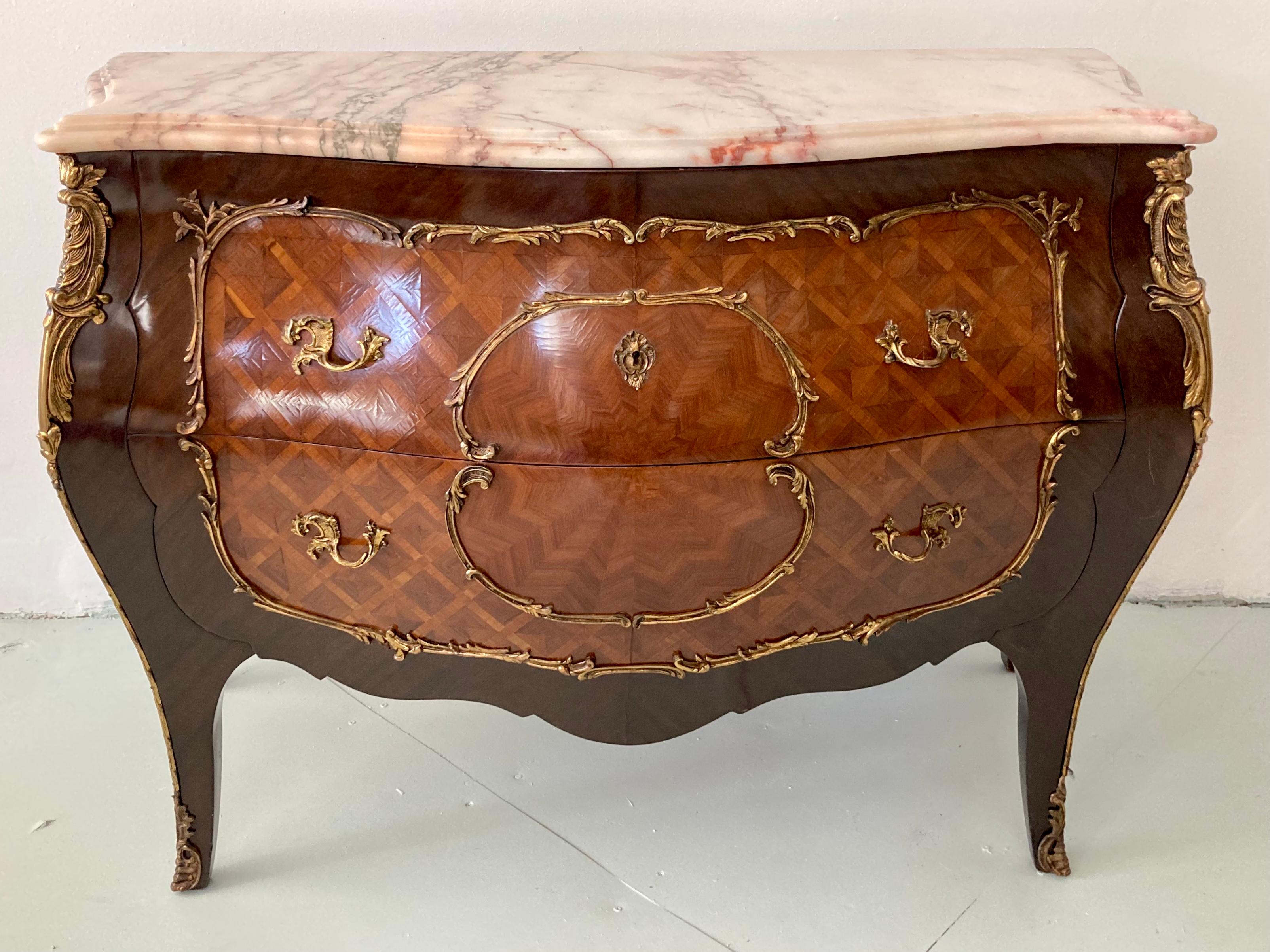 Classic Louis XV style commode with marble top. Great marquetry and ormolu details. Original Marble Top . We have 2 available in inventory. Buy both and have a fabulous pair of oversized nightstands.