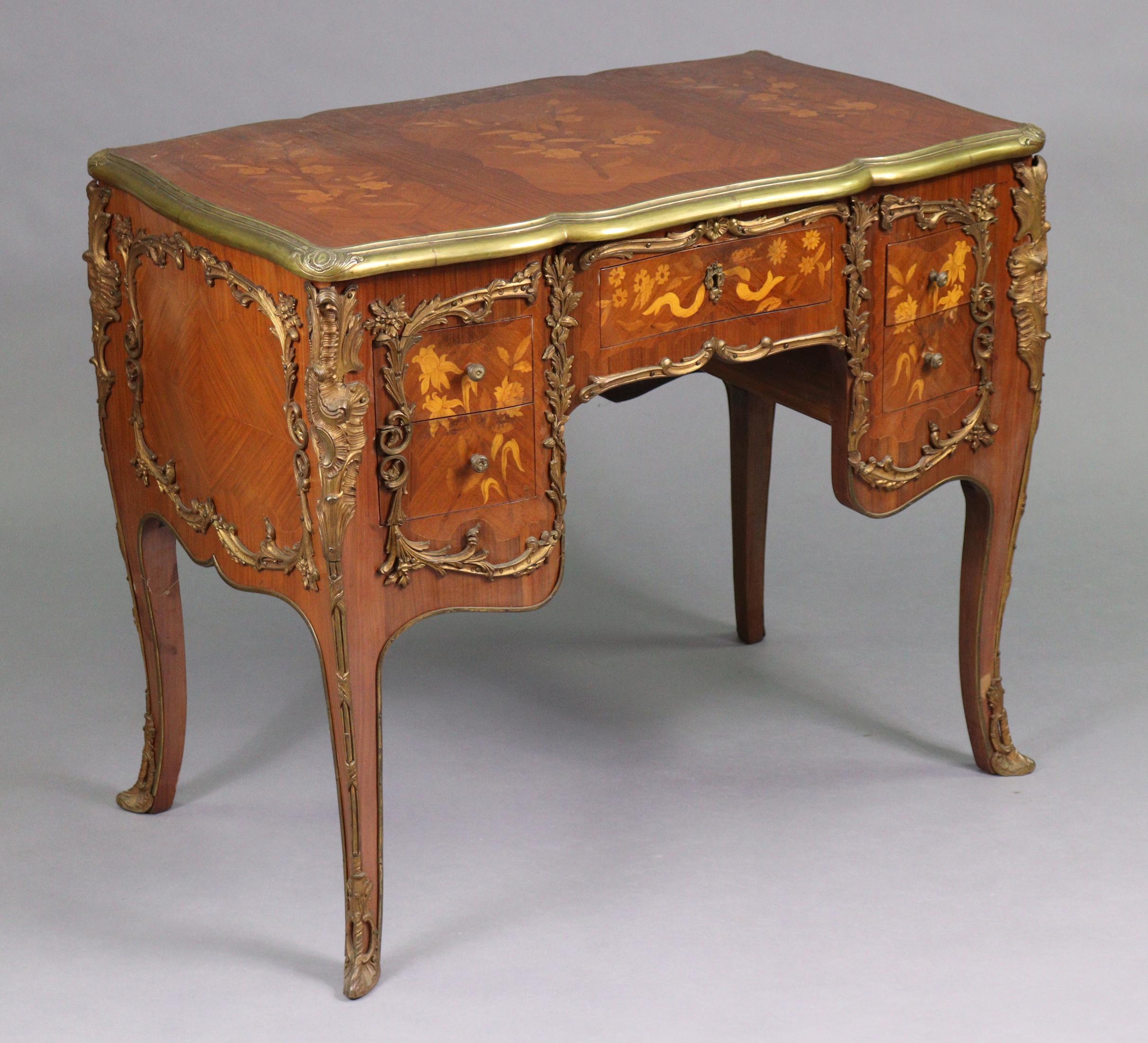 Louis XV Style Marquetry Inlaid Brass Bound Desk 

An exceptional piece in the Louis XV style, this mid-20th-century desk combines classic French elegance with refined craftsmanship. Made from kingwood, the desk is adorned with intricate marquetry