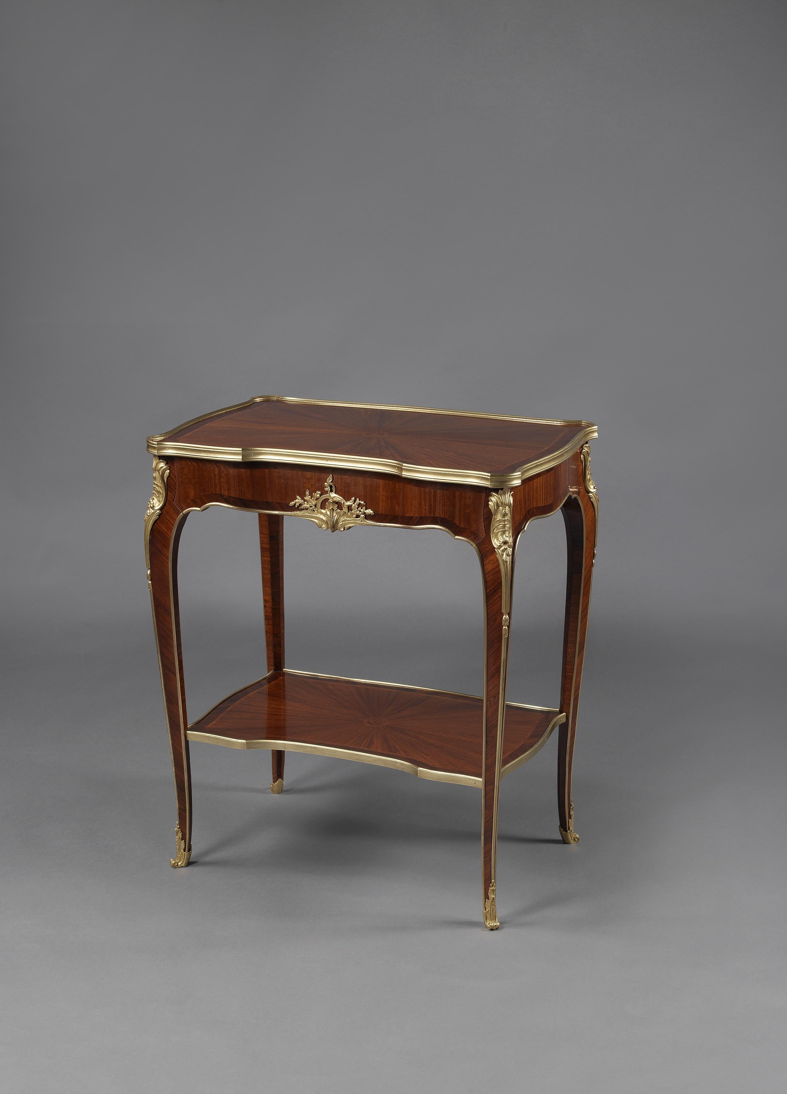 A Louis XV style gilt bronze-mounted marquetry salon table by Mercier Frères.

French, circa 1900. 

This fine petite salon table has a shaped gilt-bronze banded top inlaid with radiating parquetry above a frieze drawer centred by a foliate