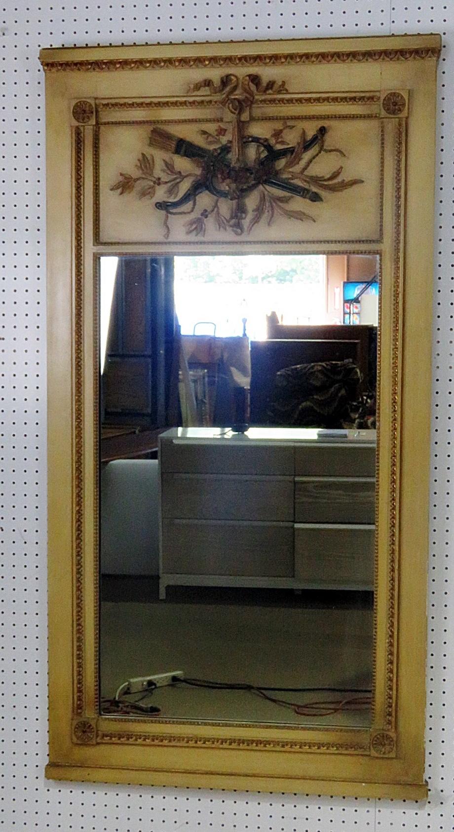 Louis XV style mirror with a distressed painted frame and gilt accents.