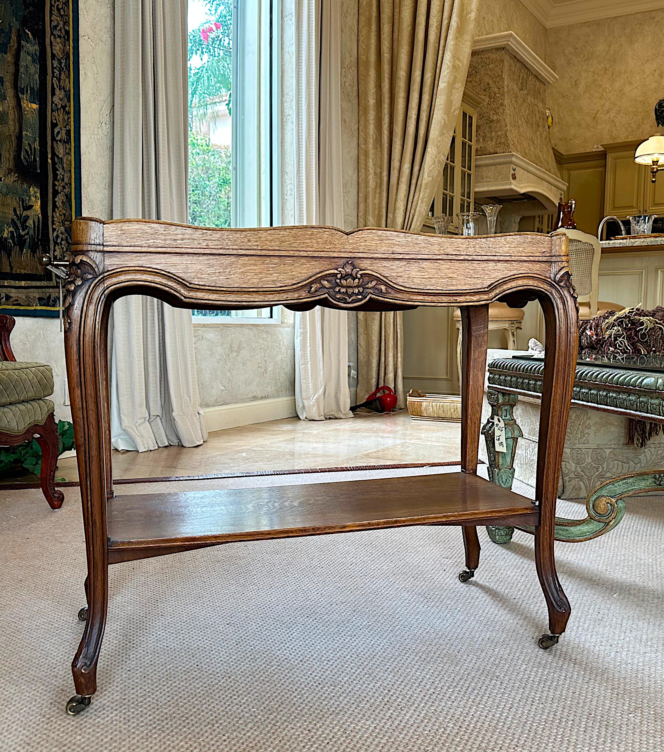 
Louis XV Style Mirror-Inset Wood Serving Table 
Rectangular, with a wooden gallery, and brass hand-hold at one side, on cabriole legs, joined by a shelf stretcher.
Height 30 in. (16.2 cm.), Width 35 in. (88.9 cm.), Depth 17 in. 43.18 cm.)