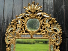 Louis XV style mirror with glazing beads in gilded wood, early 19th century