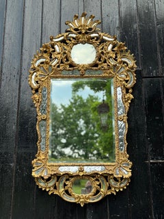 Louis XV style mirror with glazing beads in gilded wood, early 19th century