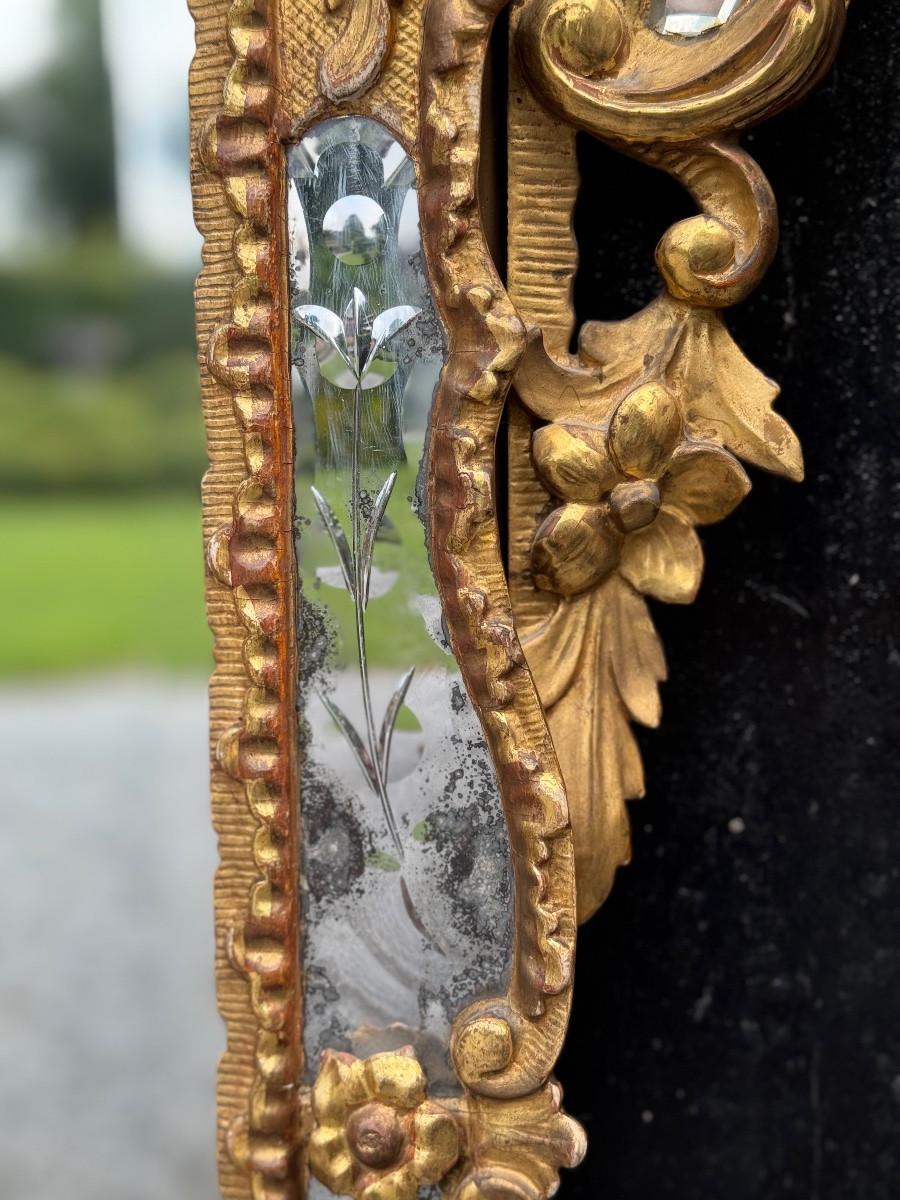 French Louis XV style mirror with glazing beads in gilded wood, early 19th century For Sale