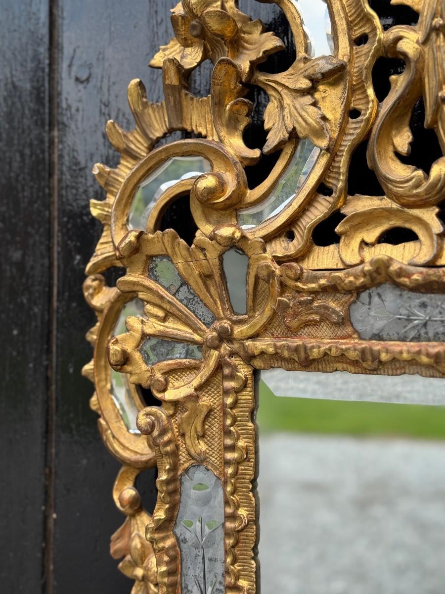 Silver Louis XV style mirror with glazing beads in gilded wood, early 19th century For Sale