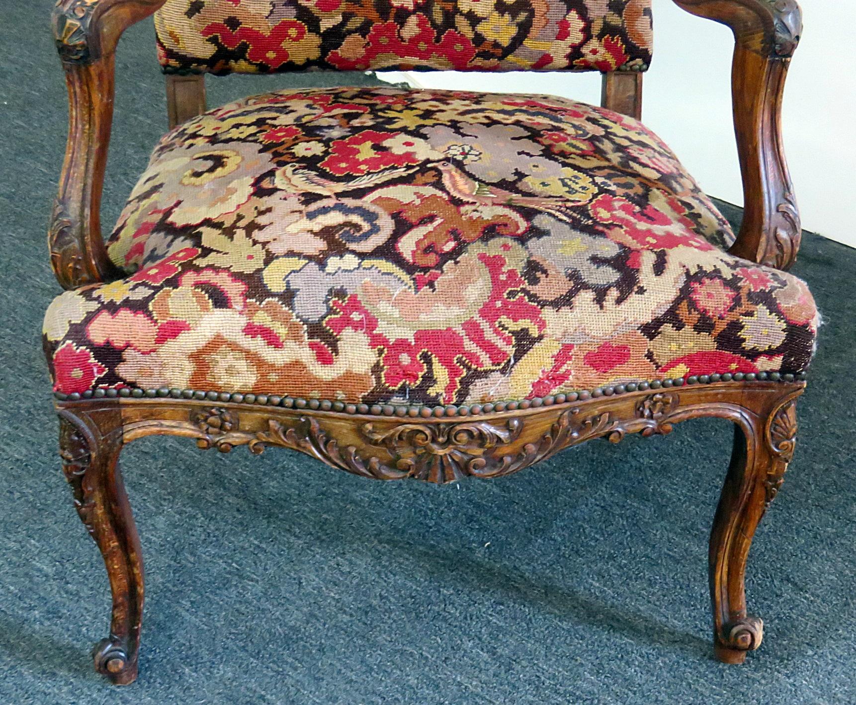 Louis XV style needle point upholstered fauteuil with nail head trim.