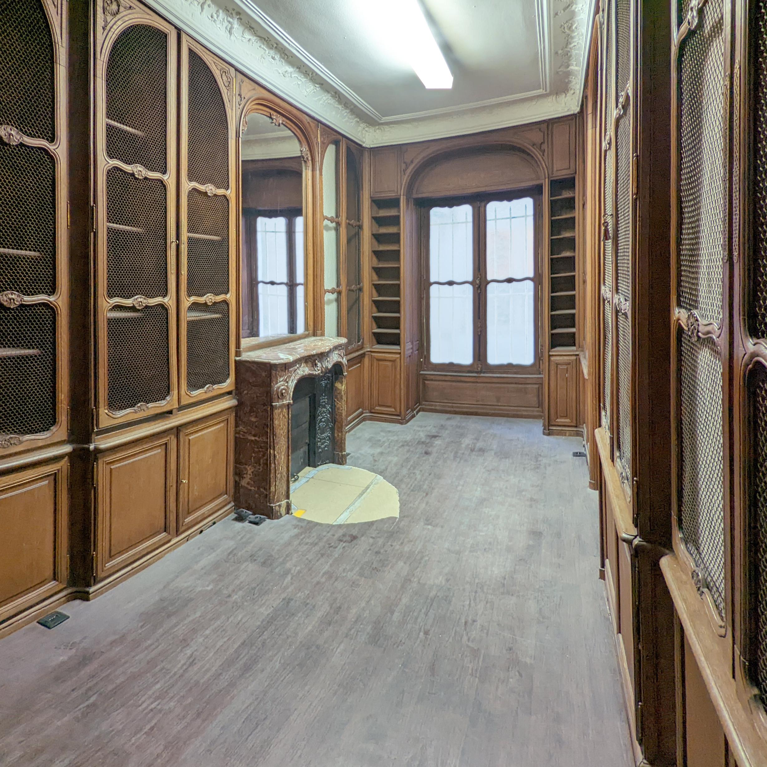Louis XV style oak paneling and bookcase, including an elegant direplace mantel