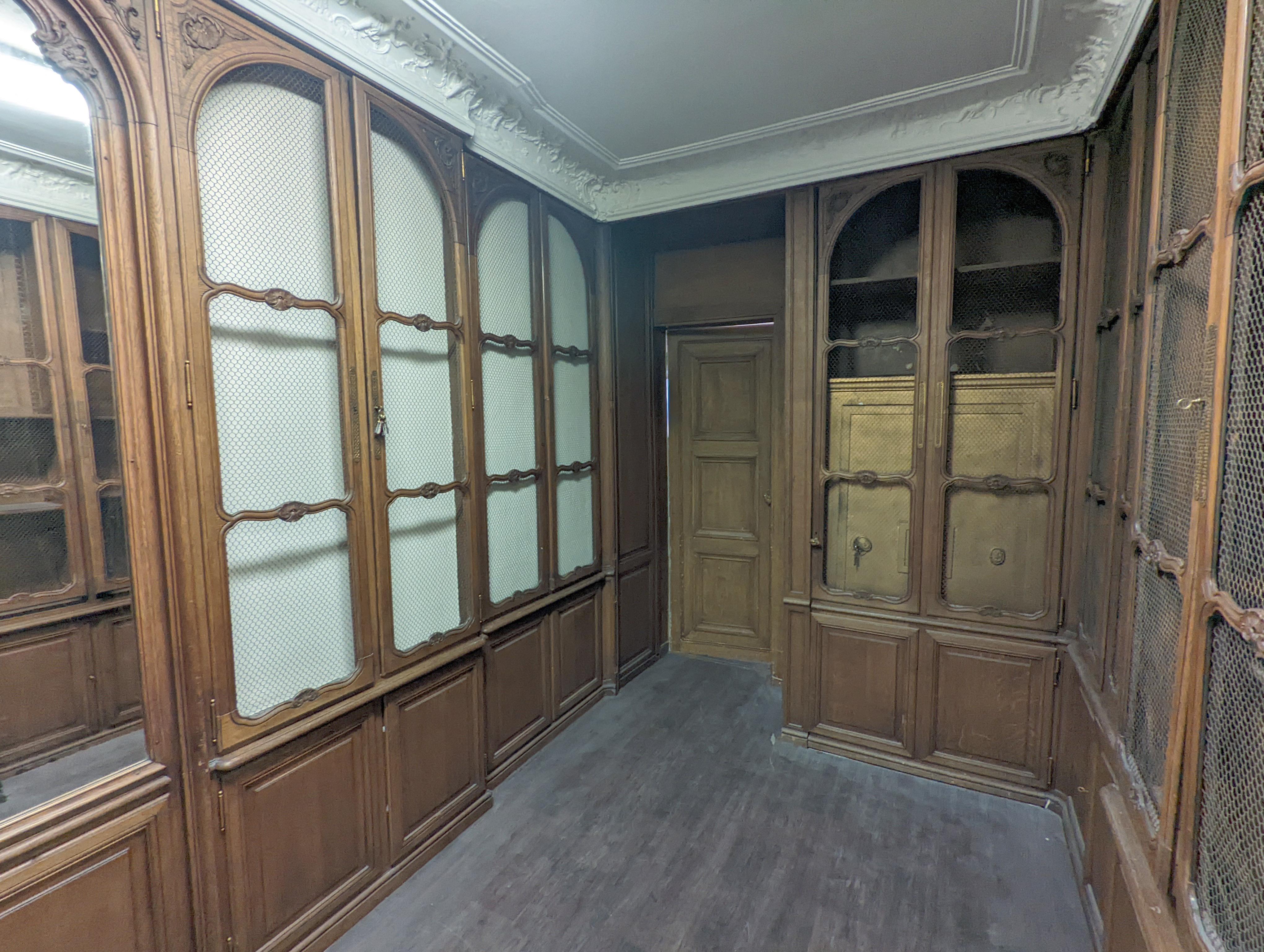 Carved Louis XV style oak paneling and bookcase including a fireplace mantel. For Sale