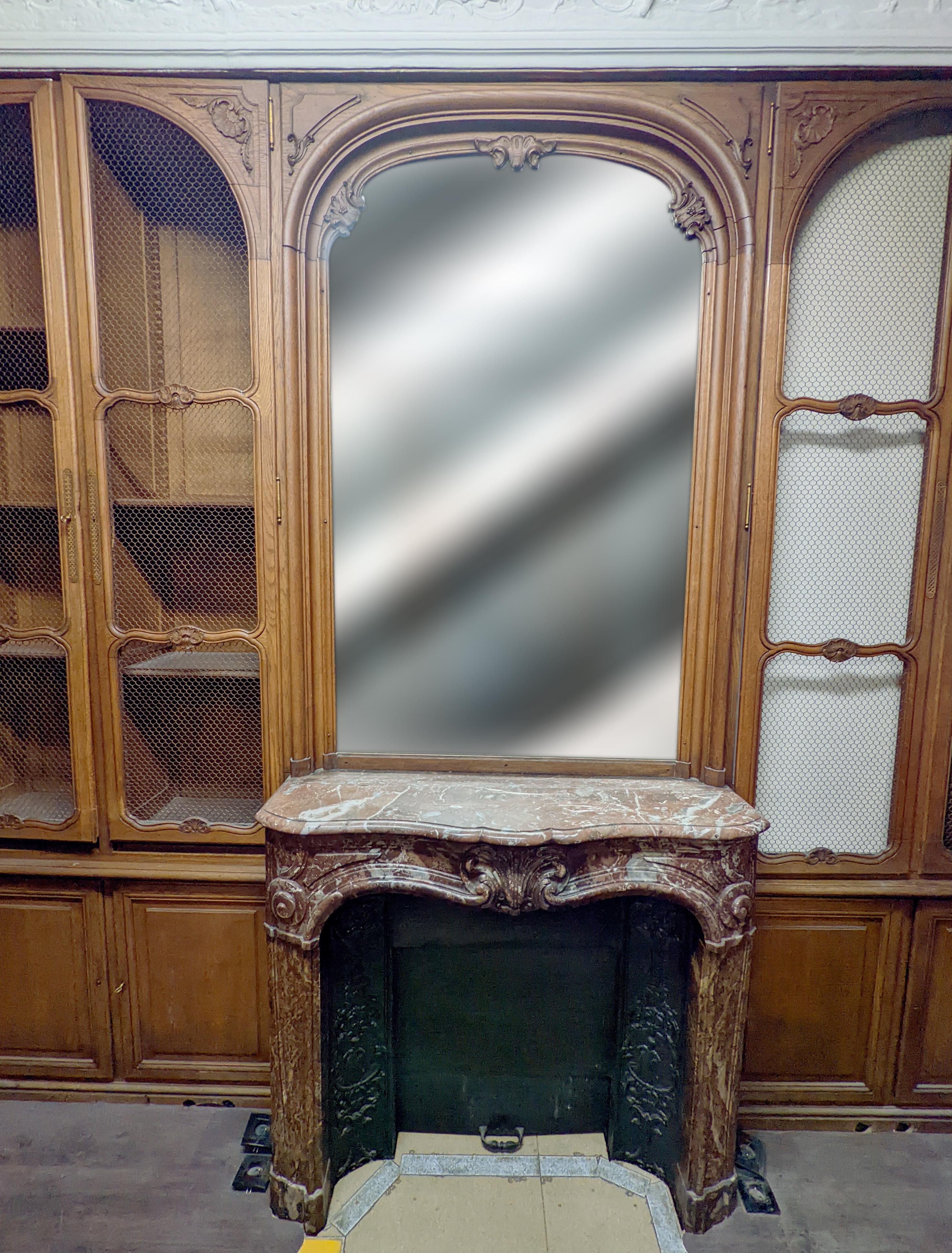 19th Century Louis XV style oak paneling and bookcase including a fireplace mantel. For Sale