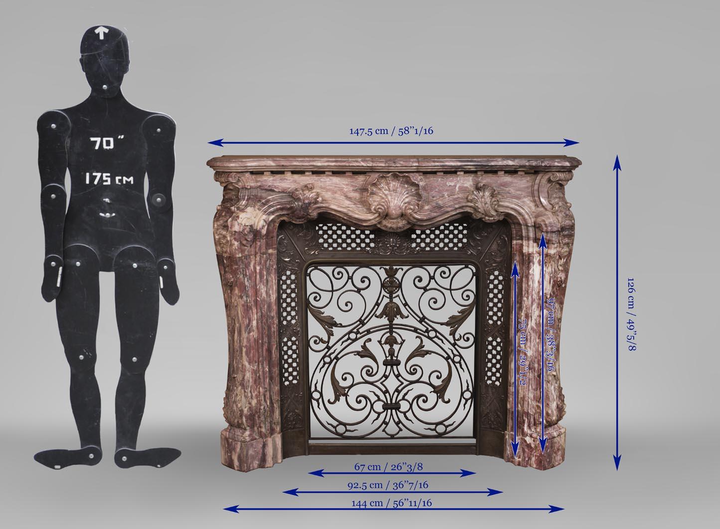 Louis XV style opulent fireplace sculpted out of Fleur de Pêcher marble For Sale 4