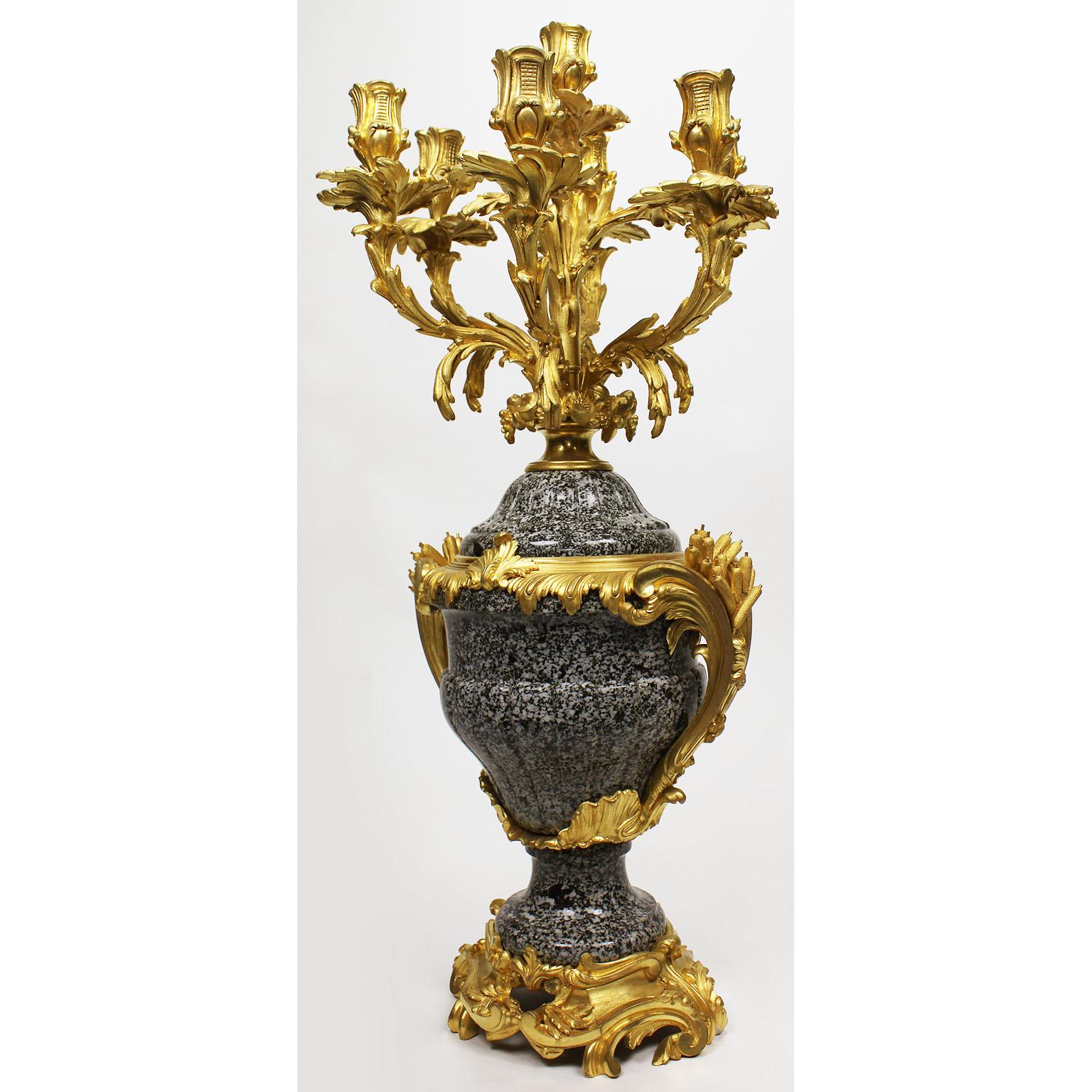 A very fine French 19th-20th century Louis XV style ormolu-mounted mottled granite-marble urn seven-light candelabra, attributed to François Linke (1855-1946). The tapering ovoid body applied with a pair of scrolled handles cast with