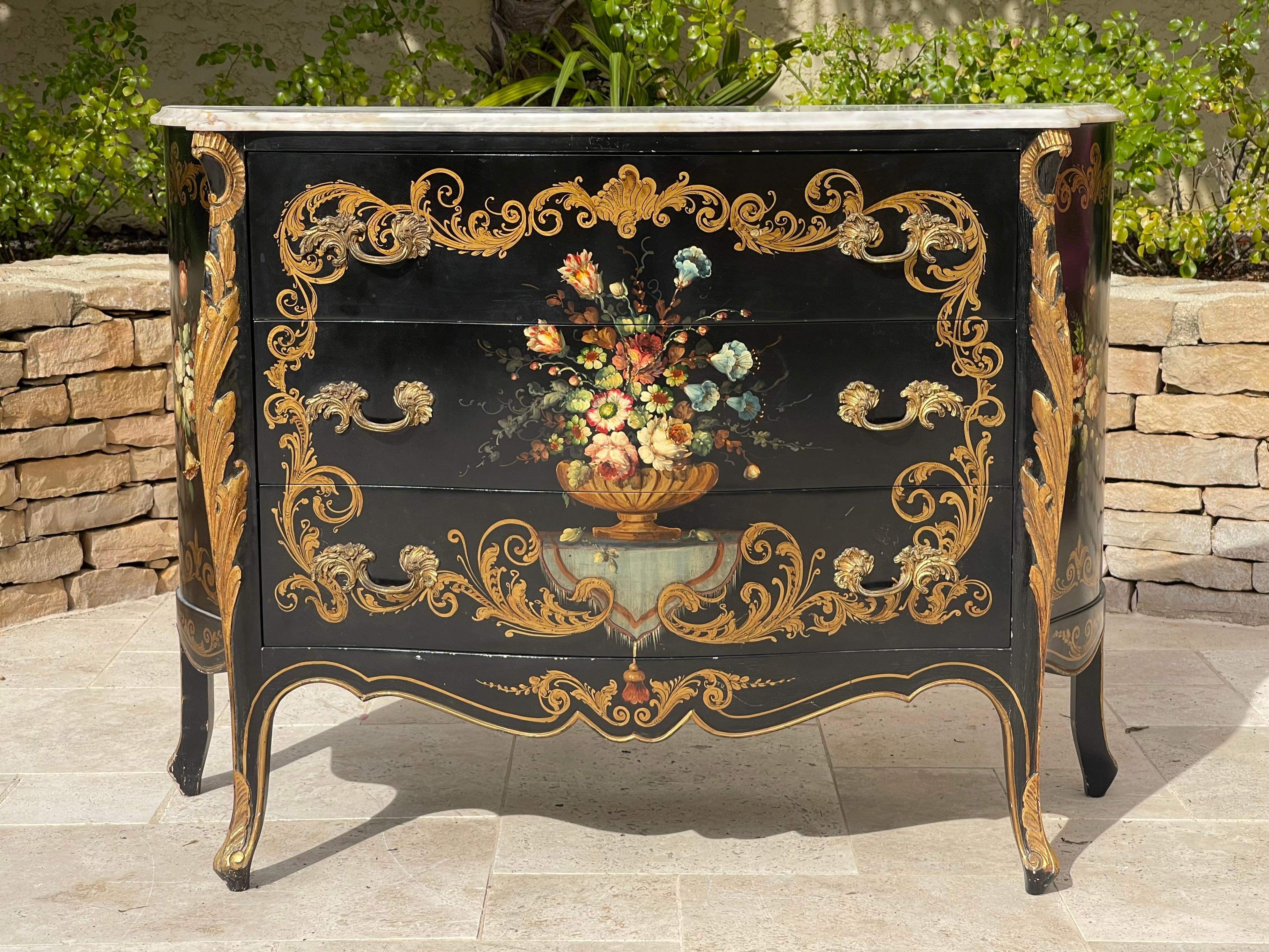 Superb chest of drawers in painted wood with floral decorations on a black background. It is decorated with gilded wood moldings, opens with three drawers with gilded bronze handles. This chest of drawers has a white marble top. 
 
 Dimensions
