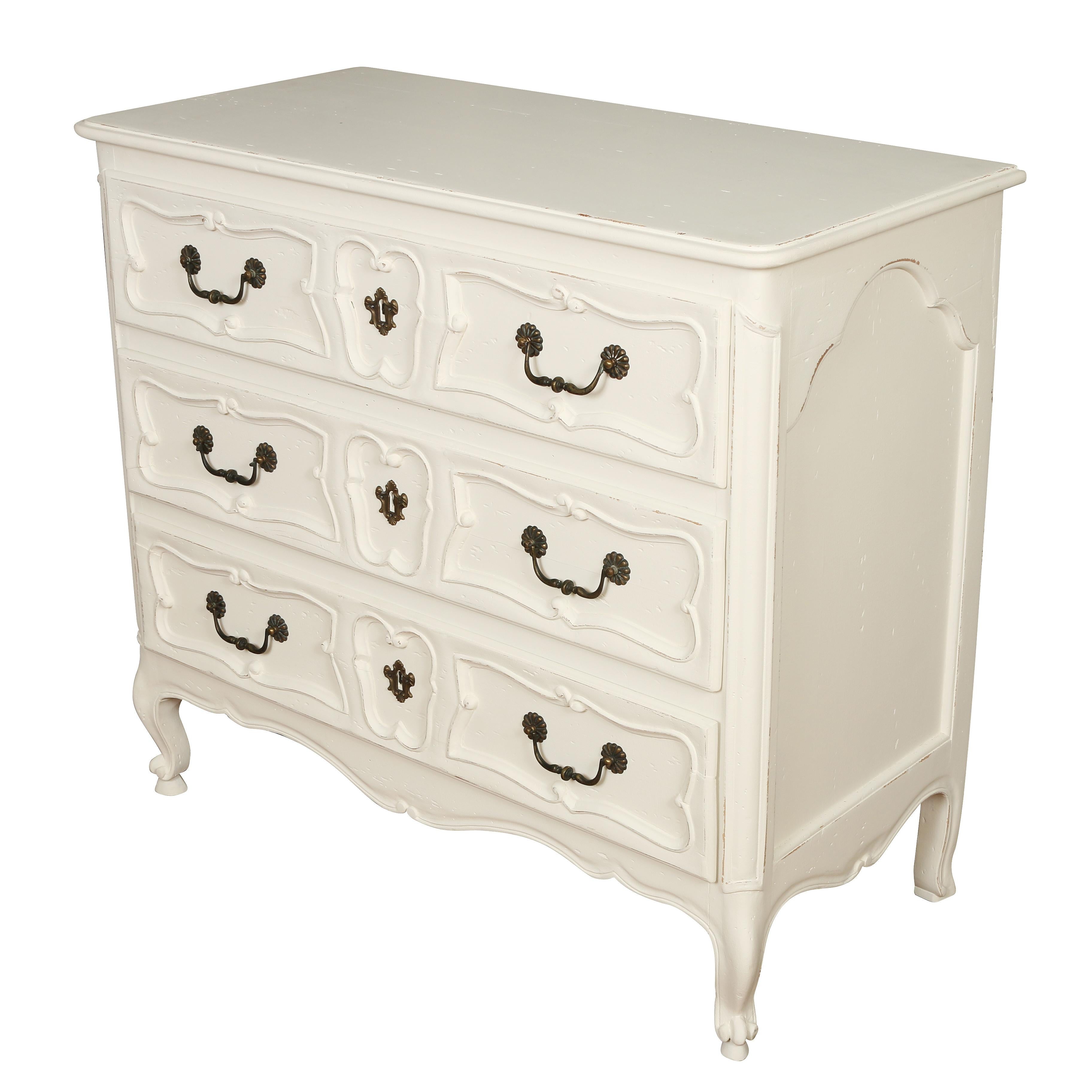 Louis XV style French commode painted white. Three drawers with bail pulls and carved wood details.