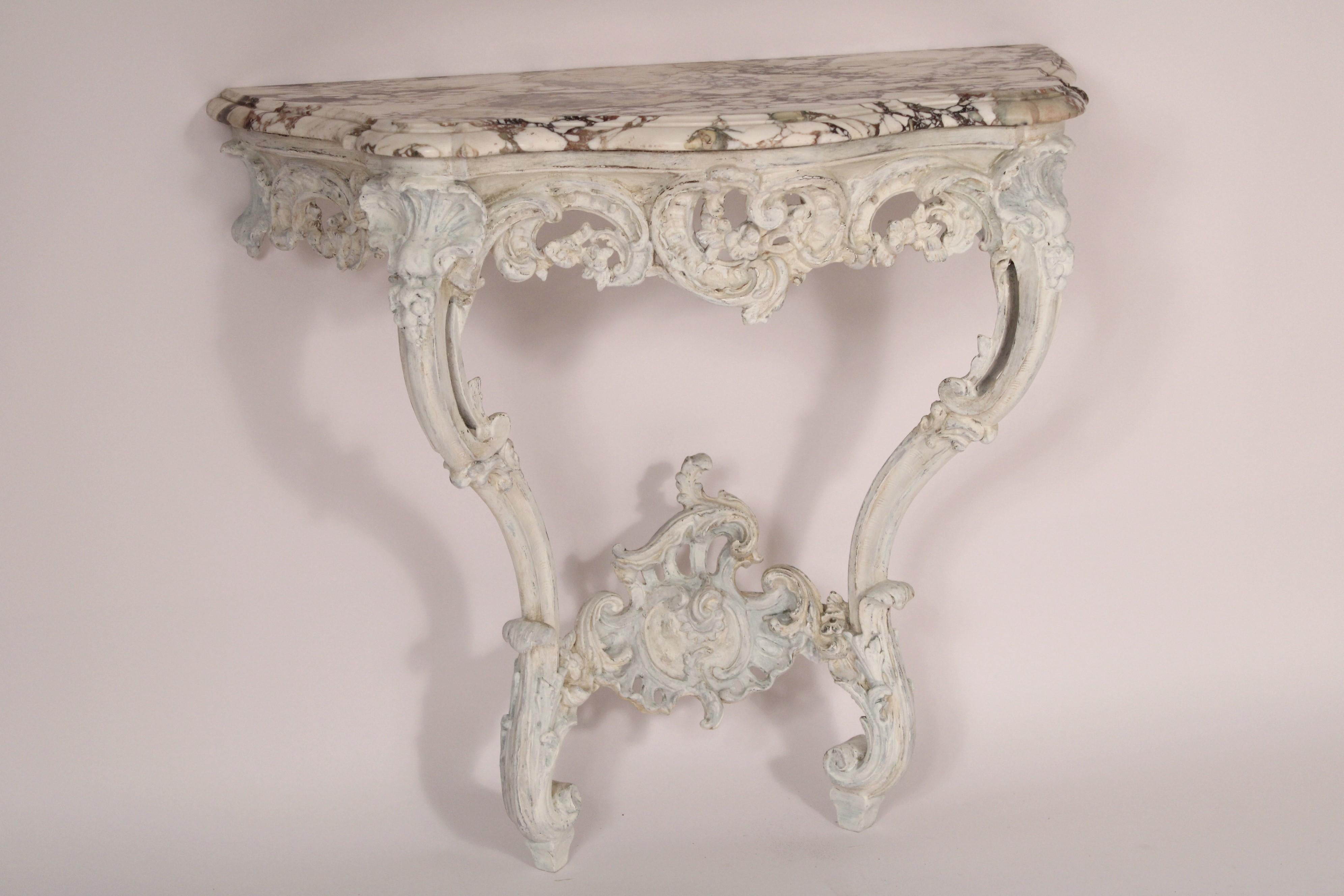 Louis XV style painted console table with marble top, circa 1930's. With an excellent quality marble top,  the frieze with floral, c scroll, and shell carvings, supported on cabriole legs. The frieze and stretcher bar is carved composition. 