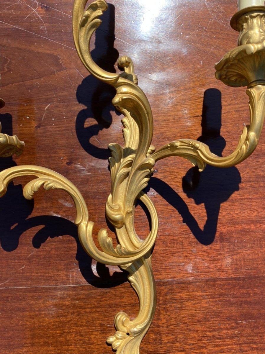 Nice pair of Louis XV style gilt bronze sconces with original gilding in very good condition. 3 light arms. Electrification is to be expected.