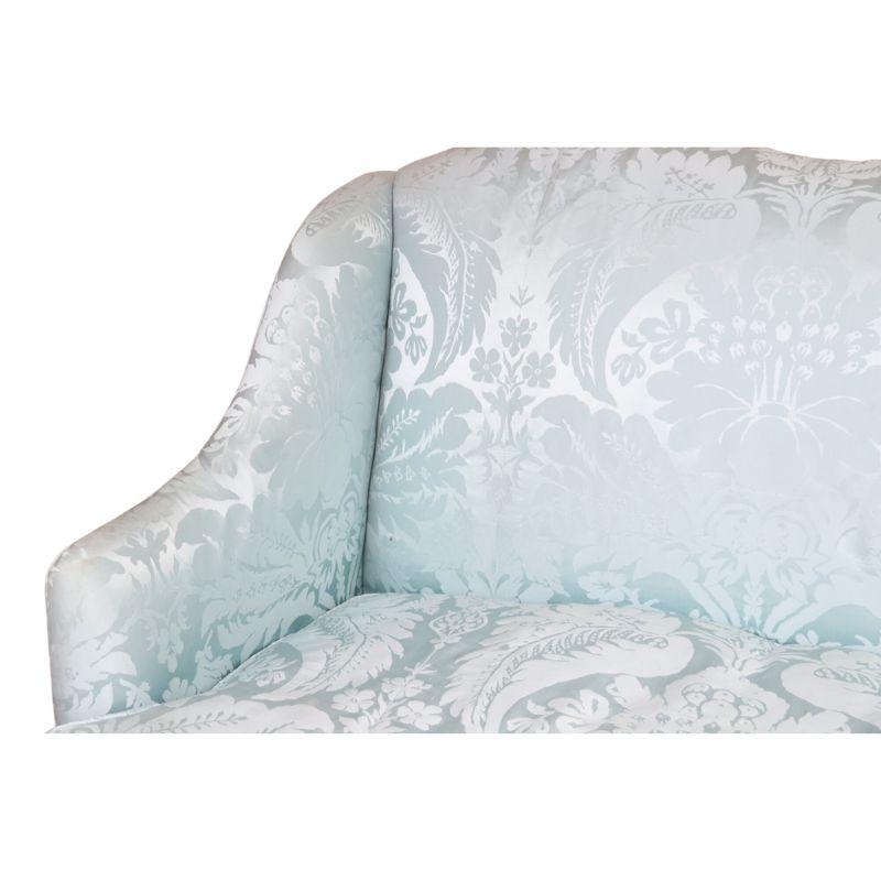An exquisite Louis XV style damask sofa with a gilt frame, a true embodiment of timeless elegance and opulence. The sofa is adorned with a stunning light blue damask fabric that envelops the frame, exuding an air of sophistication and refinement.