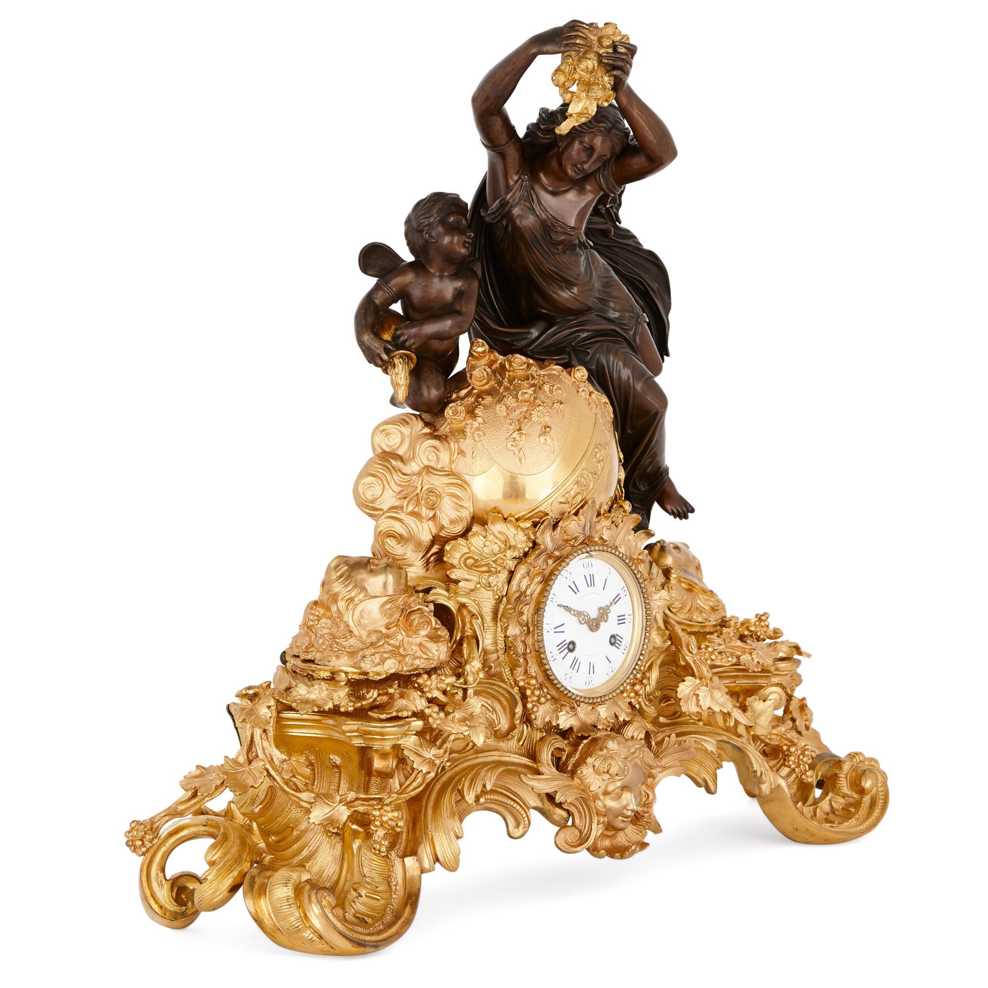 This opulent late-19th century mantel clock—with its profusion of C-scrolls and stylised foliage, as well as classical masks and dynamic sculptural figures—is clearly inspired by the luxury arts of the Louis XV period (1715-1174) in France. 

The