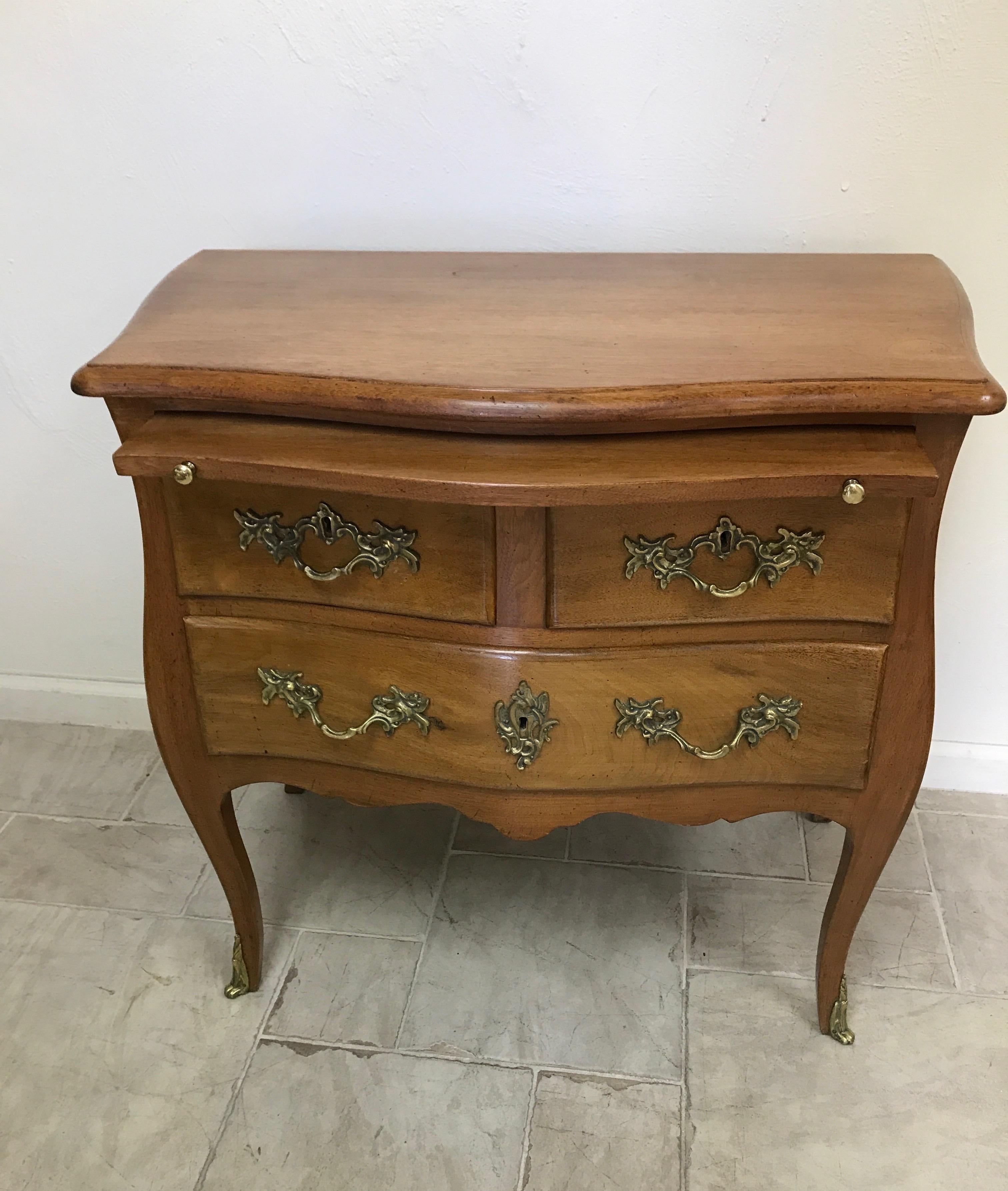 Three drawer side table/commode with pull out extension above drawers.