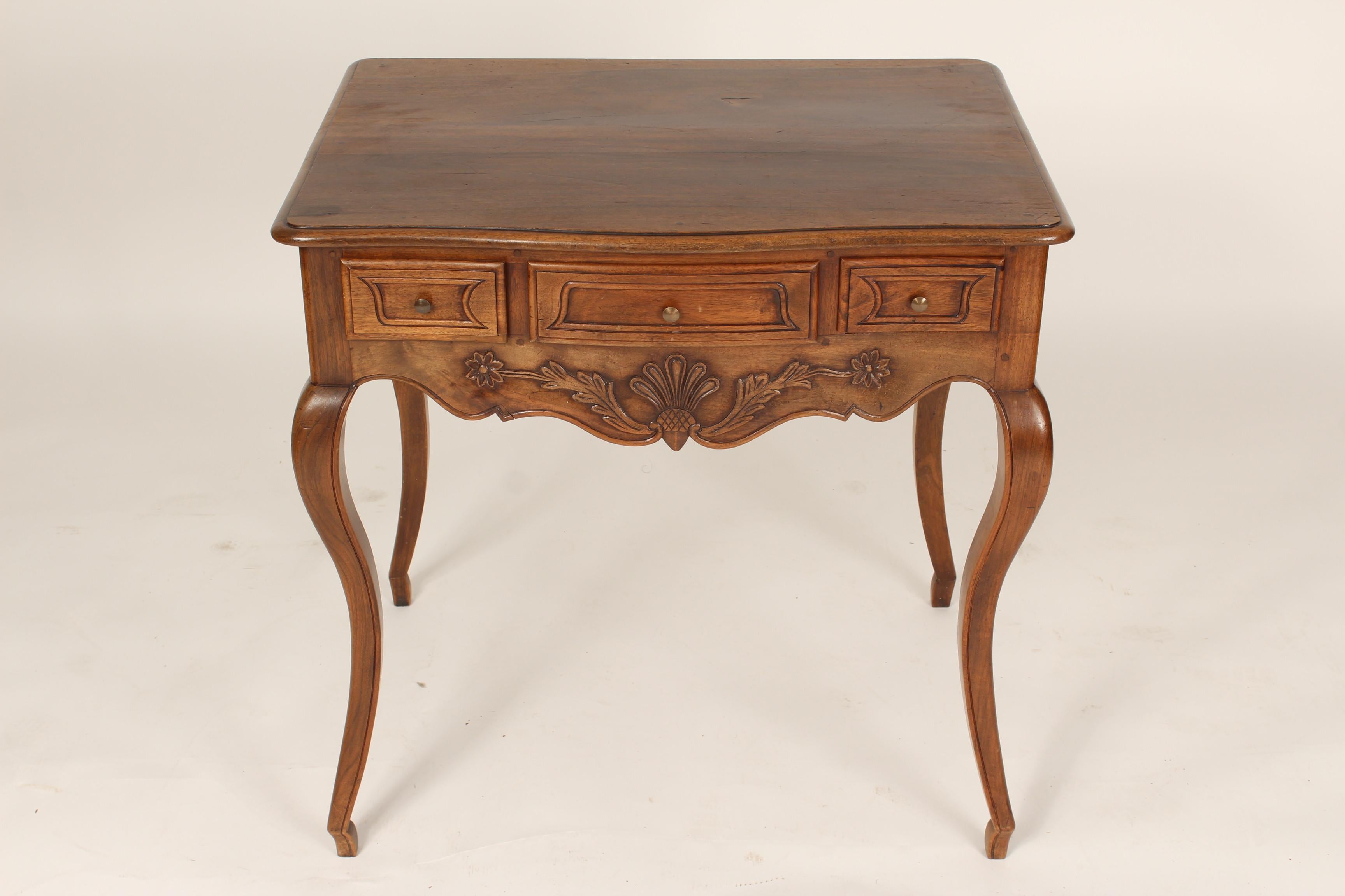 Louis XV style carved walnut occasional table with three drawers, circa 1920.