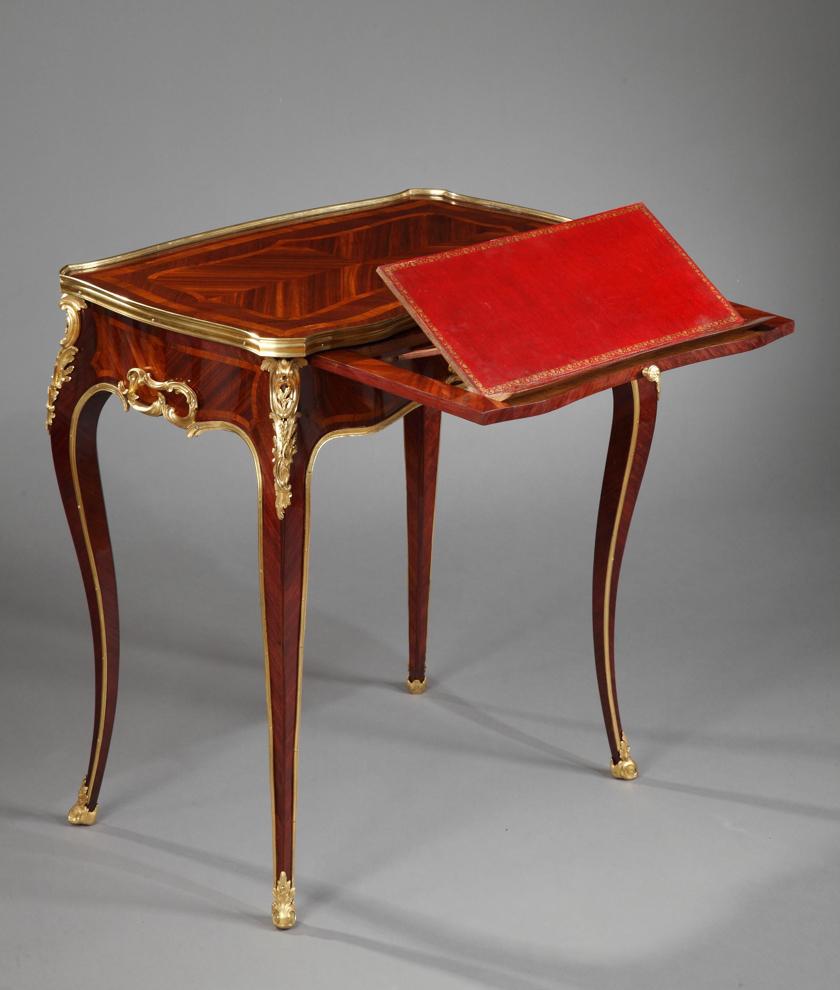 Charming Louis XV style reading table attributed to H. Dasson. It opens on one side by a compartmental drawer and by a sliding shelf, forming a writing board and being able to switch to a reading position. Its tray in veneered wood is circled by a