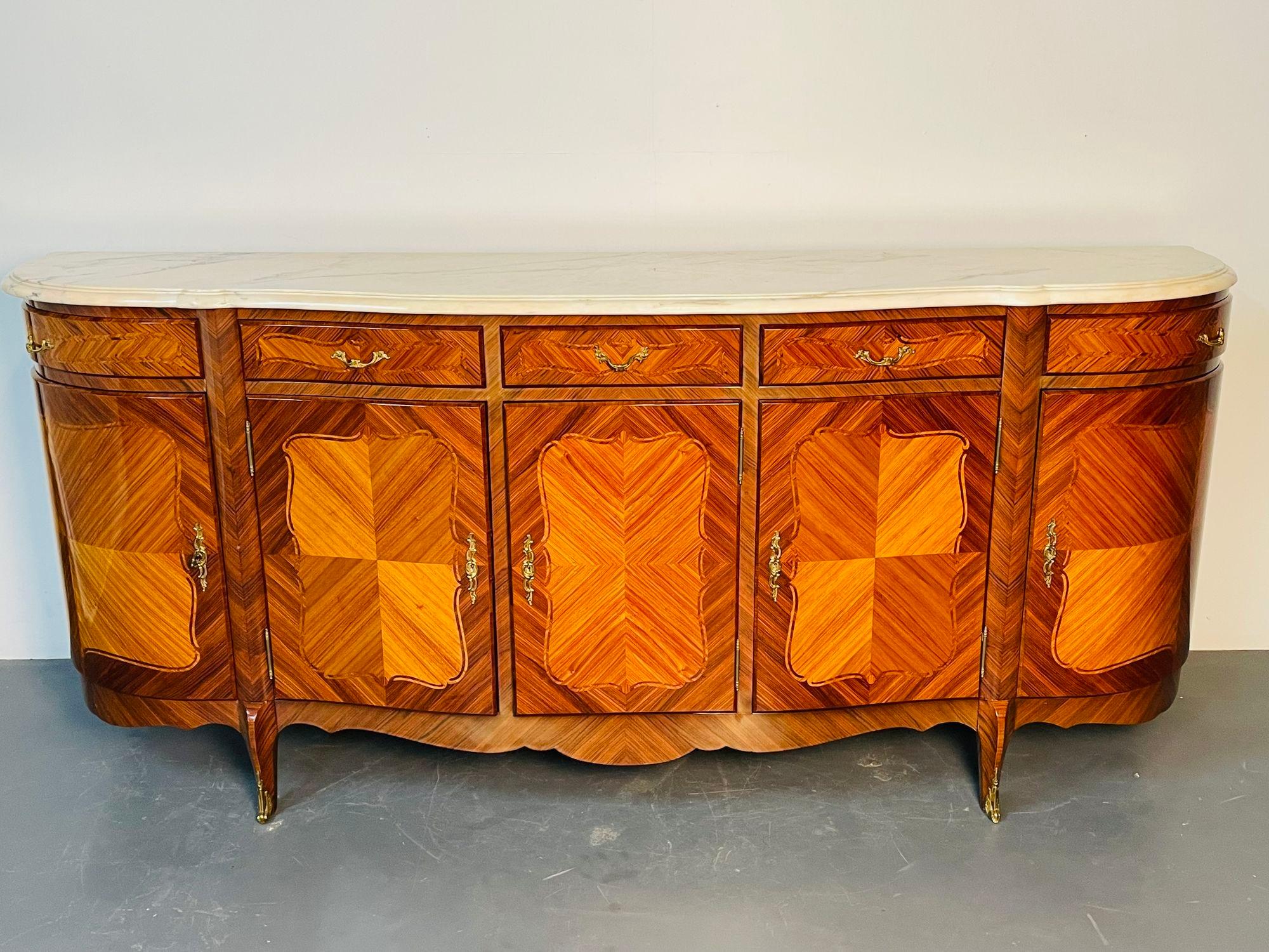 Monumental French Louis XV Style Rosewood Inlaid Sideboard, Bronze Mounted
A French Inlaid Louis XV style Sideboard, Credenza, Buffet of Monumental Form having a thick marble top with pink hues supported by a vintage custom French cabinet maker