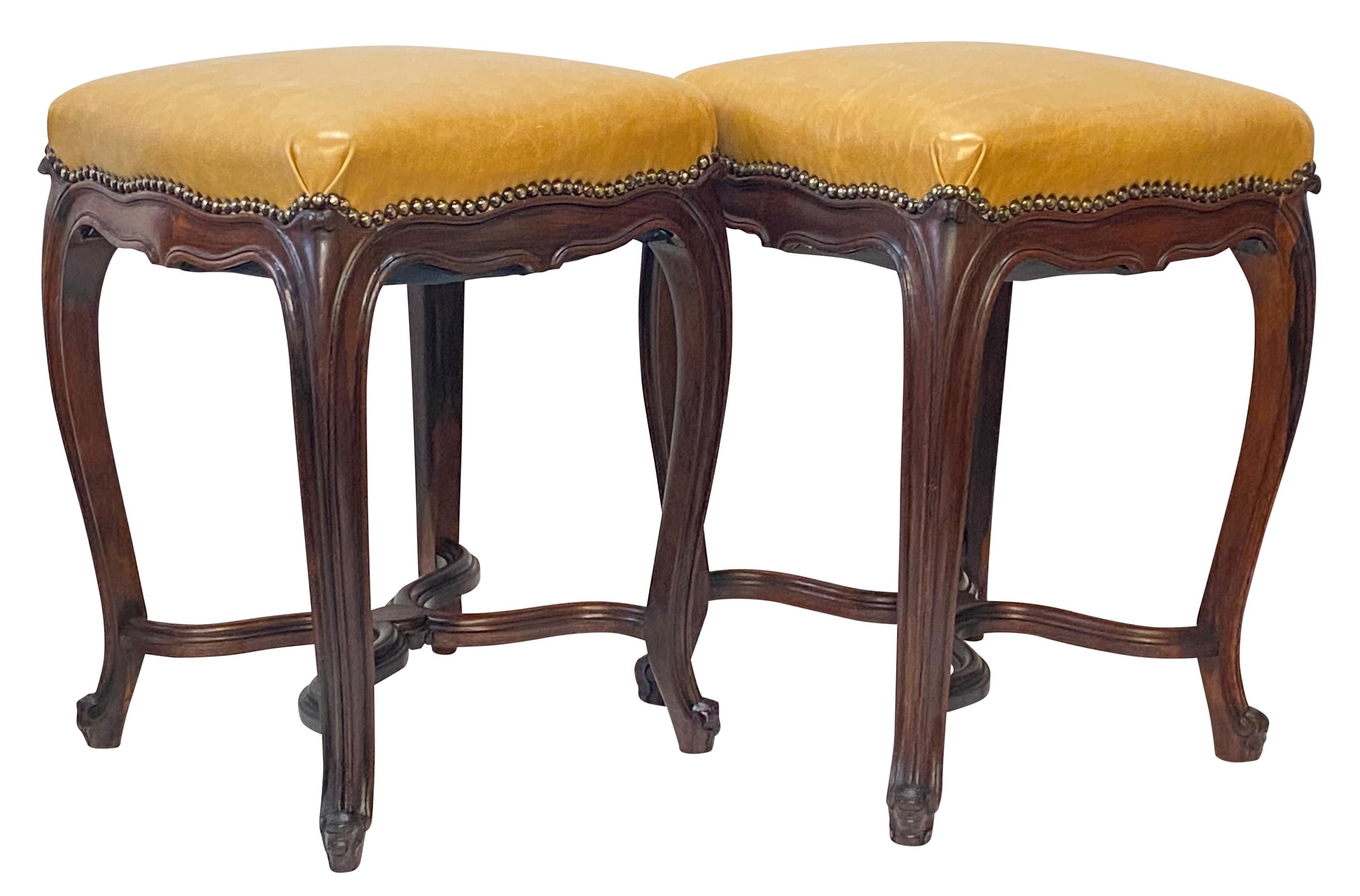 A pair of elegant Louis XV style carved rosewood stools or tabourets with nailhead detail, and recently recovered with leather upholstery.
In excellent condition, sturdy and sound
France, 19th century.