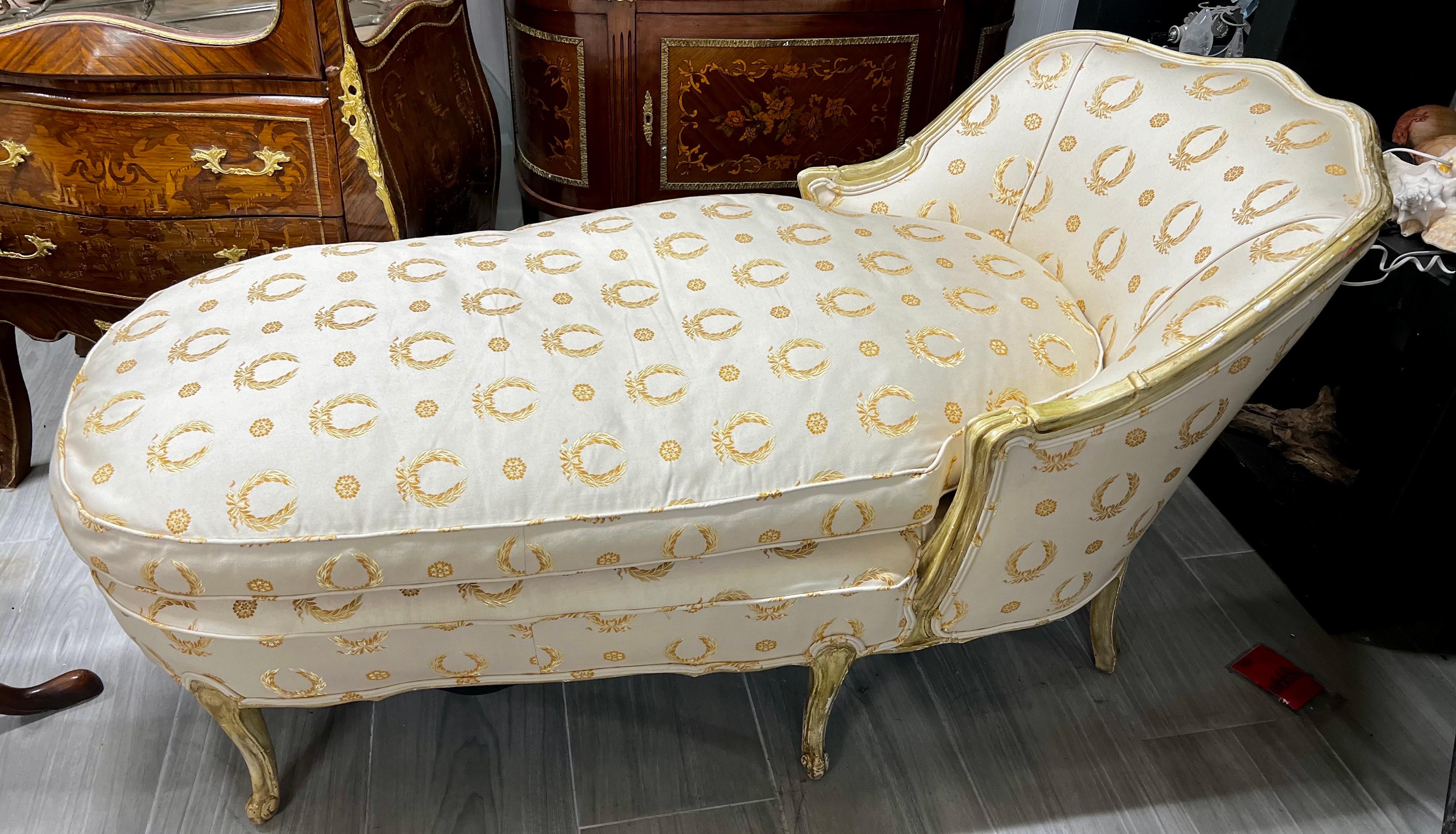 Elegant gilt chaise lounge with Scalamandre laurel wreath silk upholstery that is a couple of years old only. Very rich and luxurious looking. Down cushion.